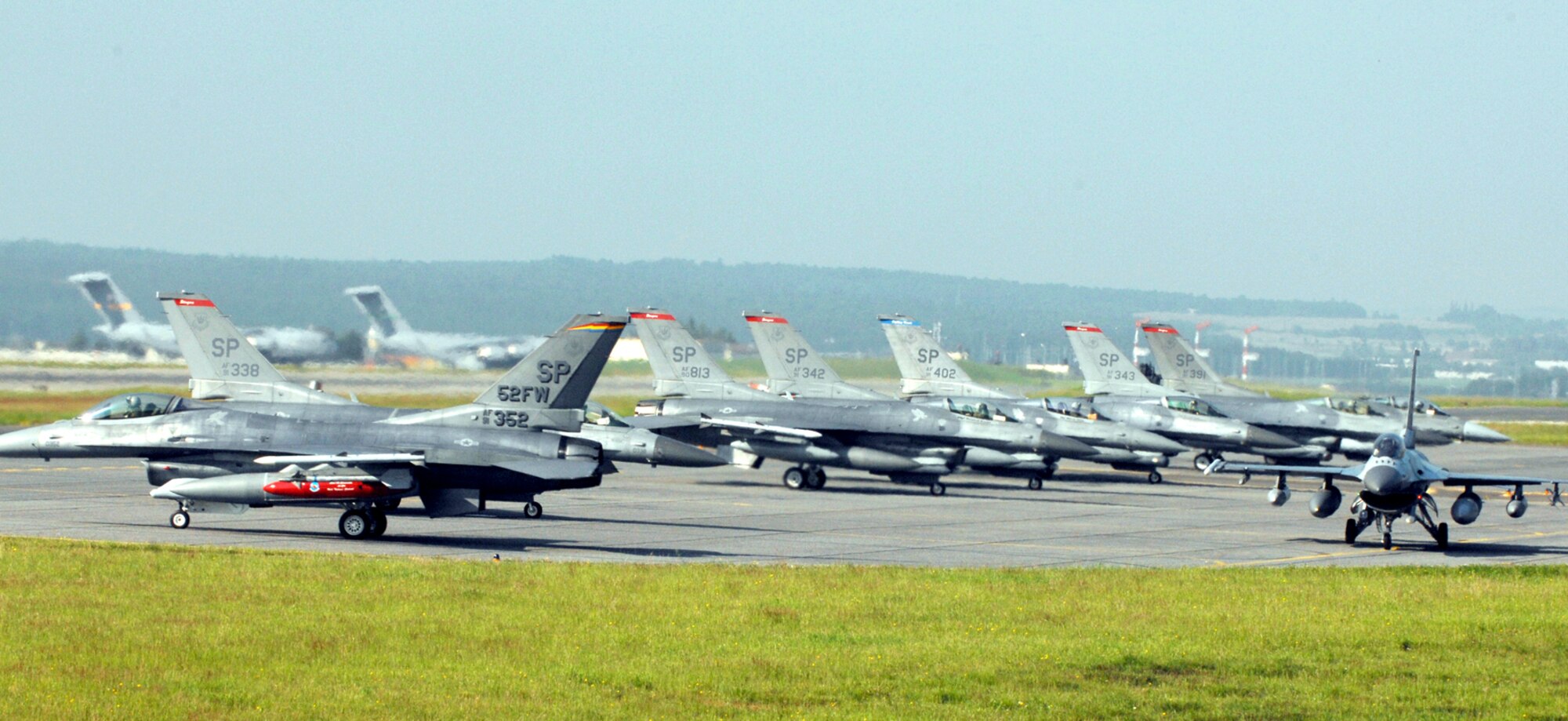 SPANGDAHLEM AIR BASE, GERMANY -- Pilots from the 22nd Fighter Squadron taxi F-16 aircraft out to the runway June 11 in preparation for their flight to Nellis Air Force Base, N.V. Pilots and crew members from the 22nd FS are deploying to Nellis AFB for the duration of Spangdahlem’s runway closure effective today until mid-July. The 81st Fighter Squadron departed June 22 for their deployment to RAF Lakenheath in England, and the 23rd Fighter Squadron will head to Buechel Air Base, Germany. (US Air Force photo/Senior Airman Josie Kemp) 