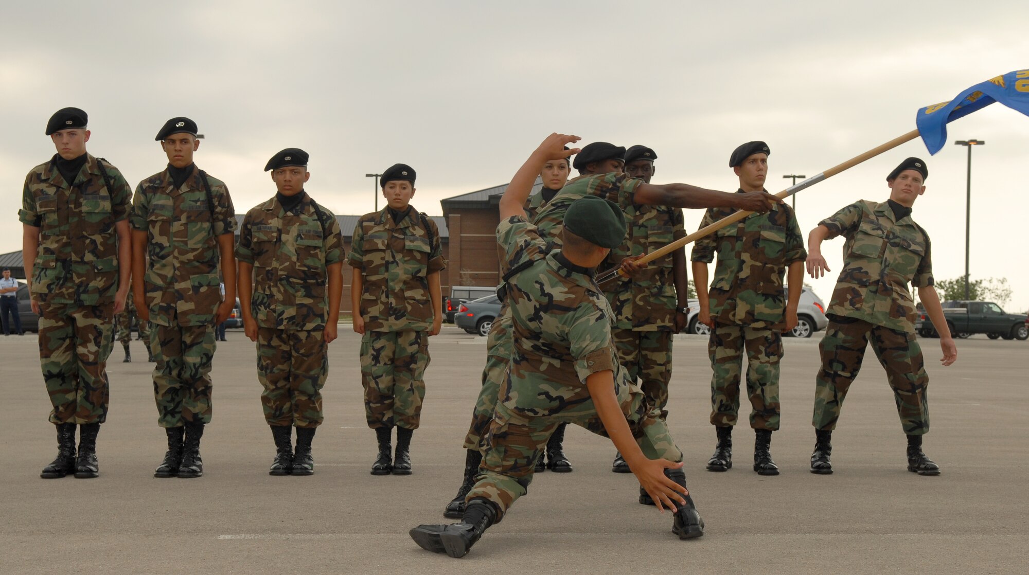 The 315th Training?Squadron drill team reacts with Matrix-style precision as the guidon bearer swings the guidon around during the exhibition portion of the 17th Training Group drill competition June 9. (U.S. Air Force photo by Tech. Sgt. Randy Mallard).