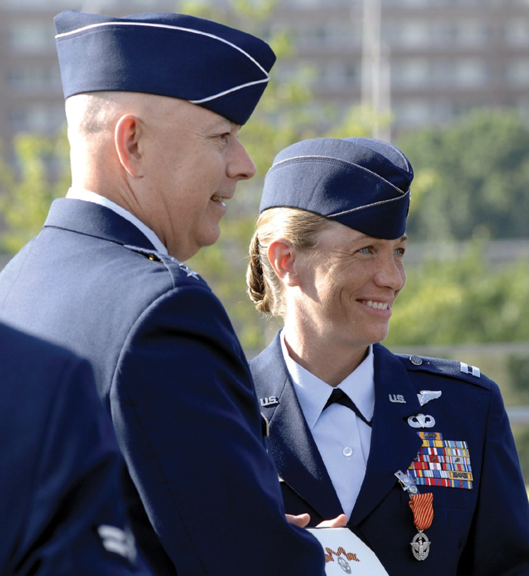 Gen. T. Michael Moseley awards Maj. Allison Black with the new Air Force Combat Action Medal at a ceremony in Washington, D.C., Tuesday. Major Black, 1st Special Operations Group, was one of six Airmen from the entire Air Force selected to participate in the historic ceremony. (U.S. Air Force photo by Ilene Allen)