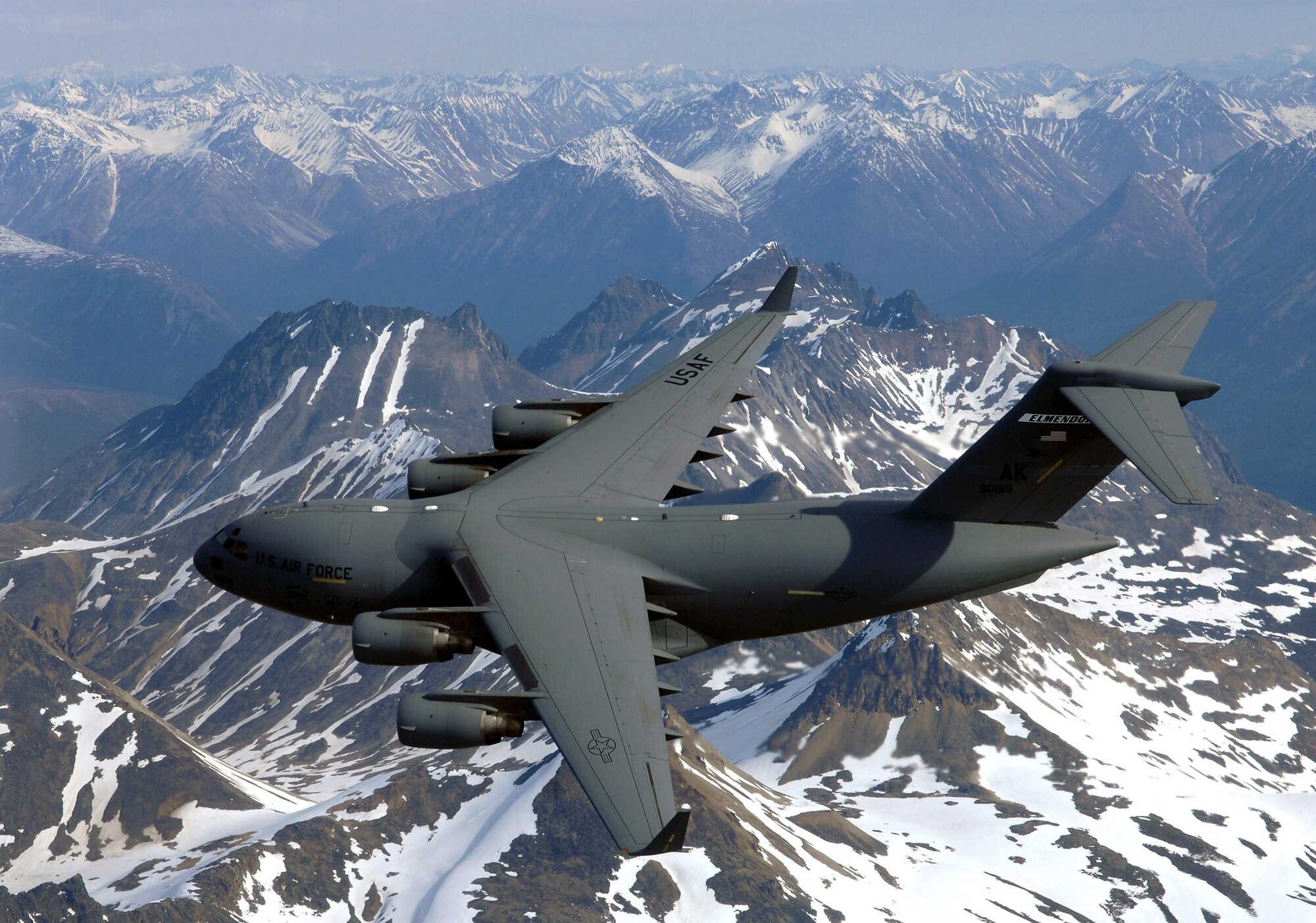 The "Spirit of Denali" flies over the Alaska Range June 11 en route to Elmendorf Air Force Base, Alaska. This C-17 Globemaster III is the first of eight to be stationed there The airlifters will be flown by active duty in the 517th Airlift Squadron and by Air National Guard in the 249th Airlift Squadron. (U.S. Air Force photo/Tech. Sgt. Keith Brown) 
