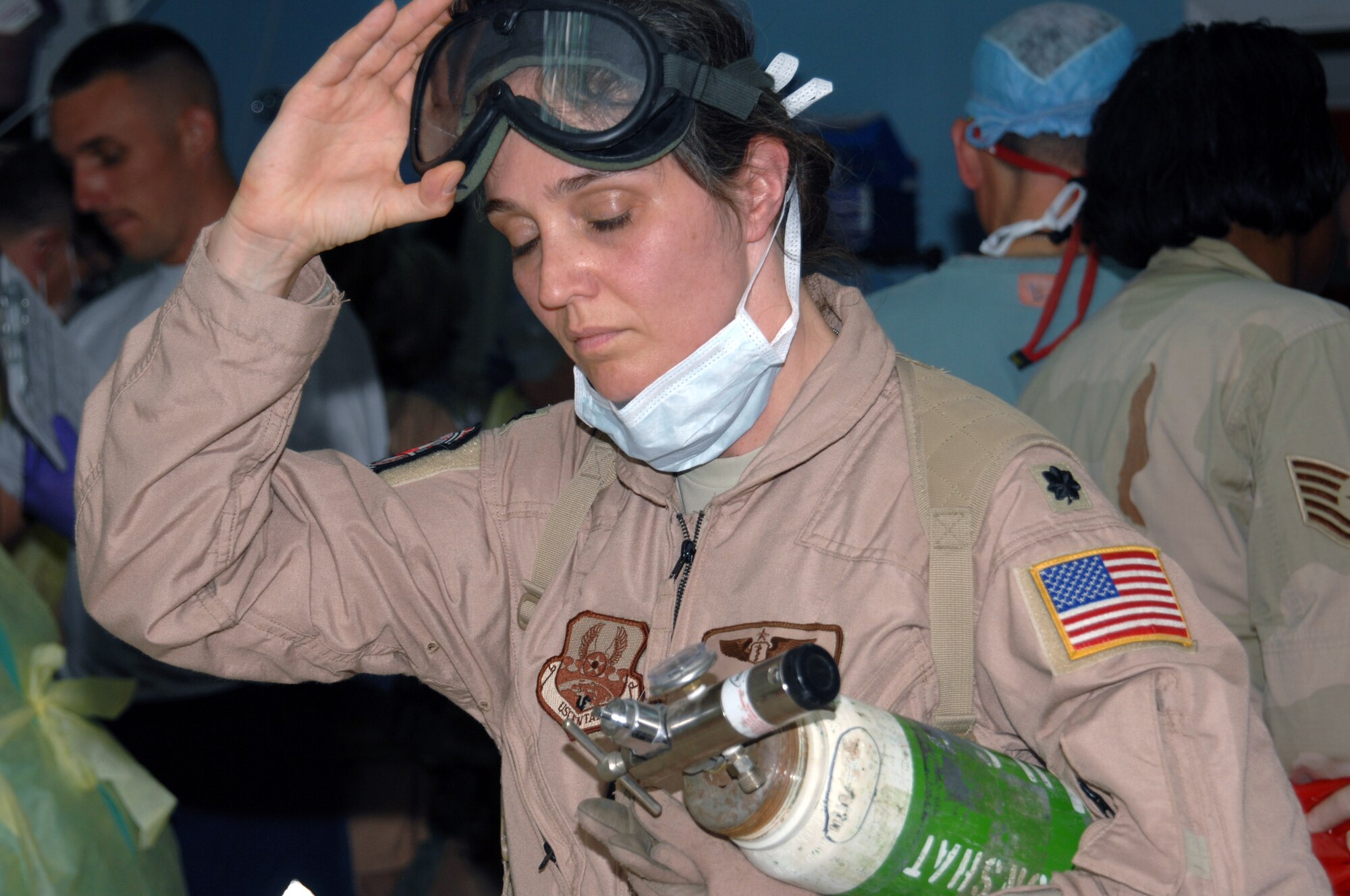 Lt. Col. Kimberly Bradley carries away an oxygen tank after helping a patient during an emergency trauma situation June 8 at Kirkuk Regional Air Base, Iraq. Colonel Bradley is with the 506th Expeditionary Medical Squadron. (U.S. Air Force photo/Senior Airman Kristin Ruleau)