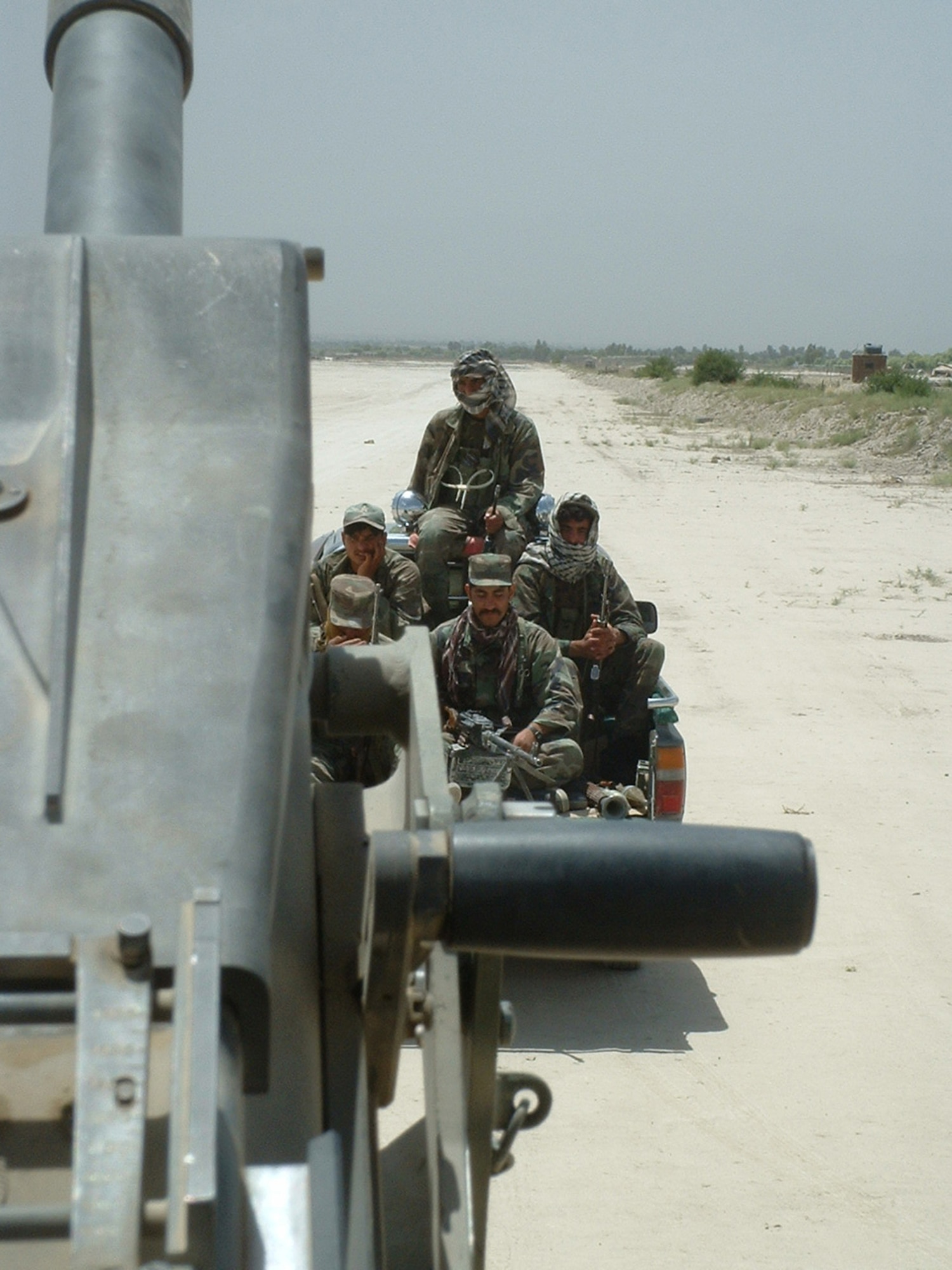 Fighters loyal to an Afghan warlord patrol alongside the special forces unit that Master Sgt. David Wilburn was assigned as a joint terminal attack controller while deployed to Afghanistan in 2003. Their mission: "Shake the bushes." (Courtesy photo)