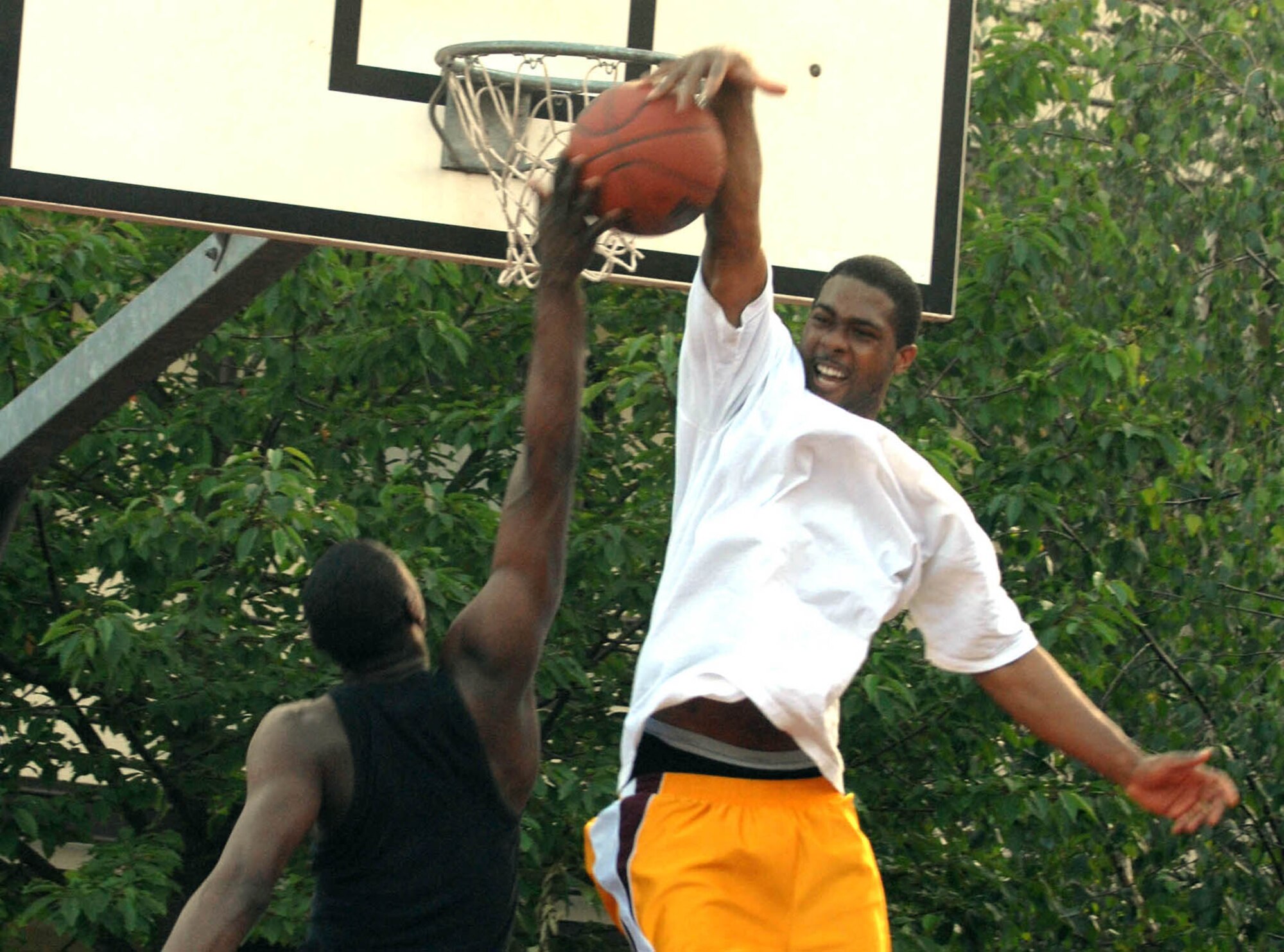 SPANGDAHLEM AIR BASE, GERMANY -- Airman 1st Class Jeremy "5000" Watts, 52nd Security Forces Squadron, blocks a shot from Airman 1st Class Jerry "Handles" Murrell during an off-duty basketball game June 7. (US Air Force photo/Airman 1st Class Stephanie Clark)