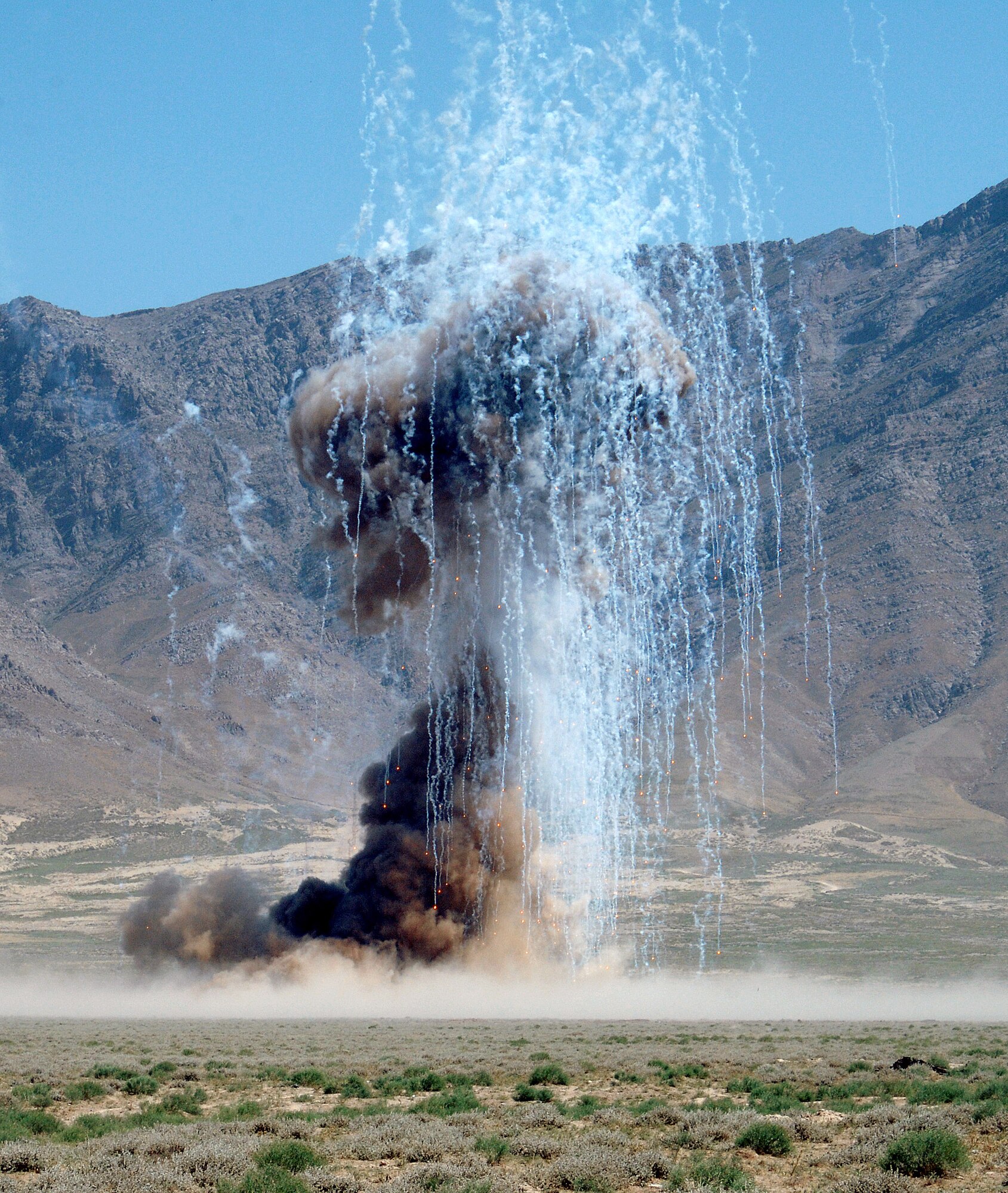This is the explosion as the 755th Expeditionary Explosive Ordnance Disposal detonation team disposes of over 1,000 pounds of stored munitions, mines, and weapons caches at a controlled detonation outside of Bagram Airfield, Afghanistan June 13. (photo by Staff Sgt. Craig Seals)