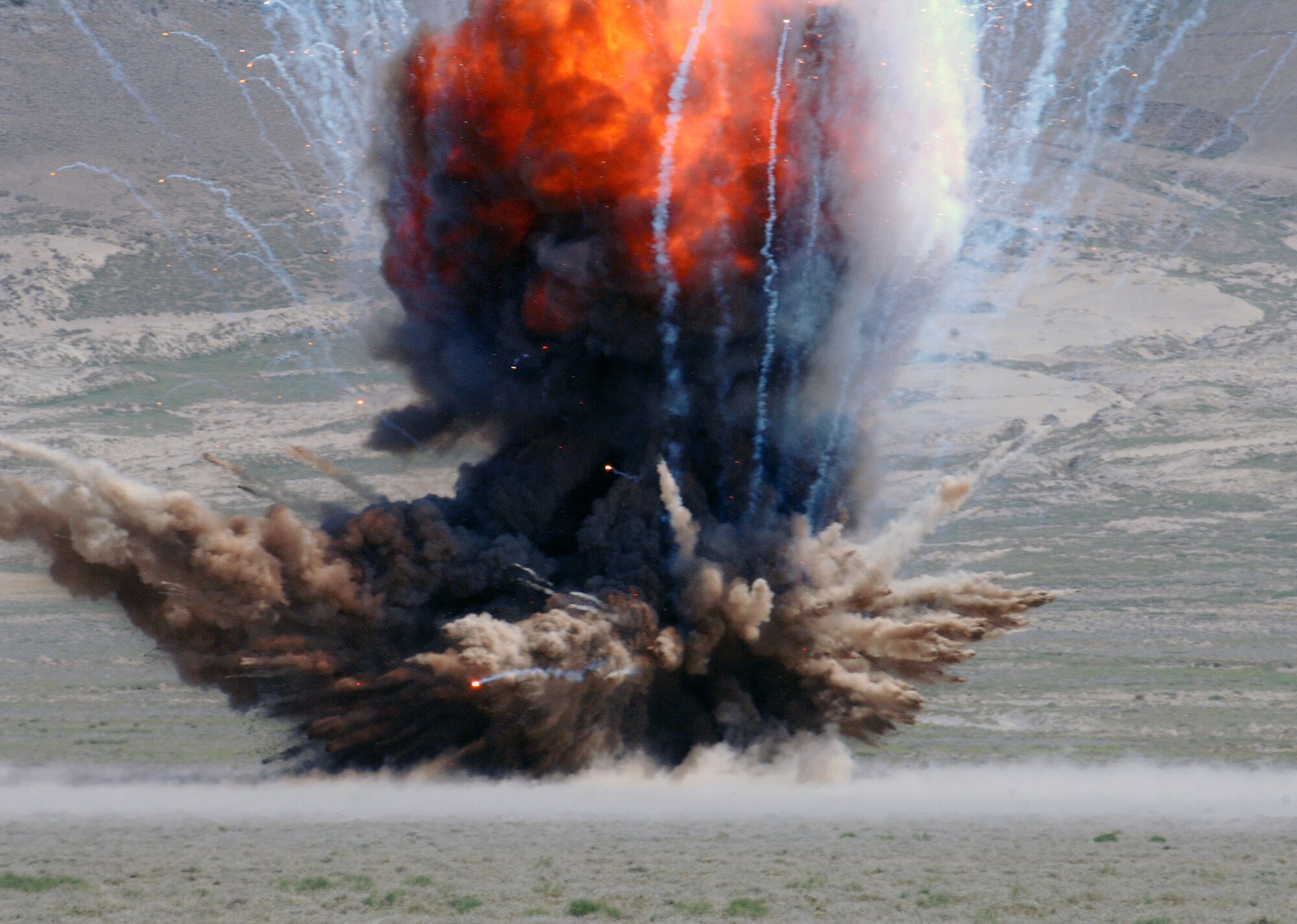 This is the explosion as the 755th Expeditionary Explosive Ordnance Disposal detonation team disposes of over 1,000 pounds of stored munitions, mines, and weapons caches at a controlled detonation outside of Bagram Airfield, Afghanistan June 13. (photo by Staff Sgt. Craig Seals)