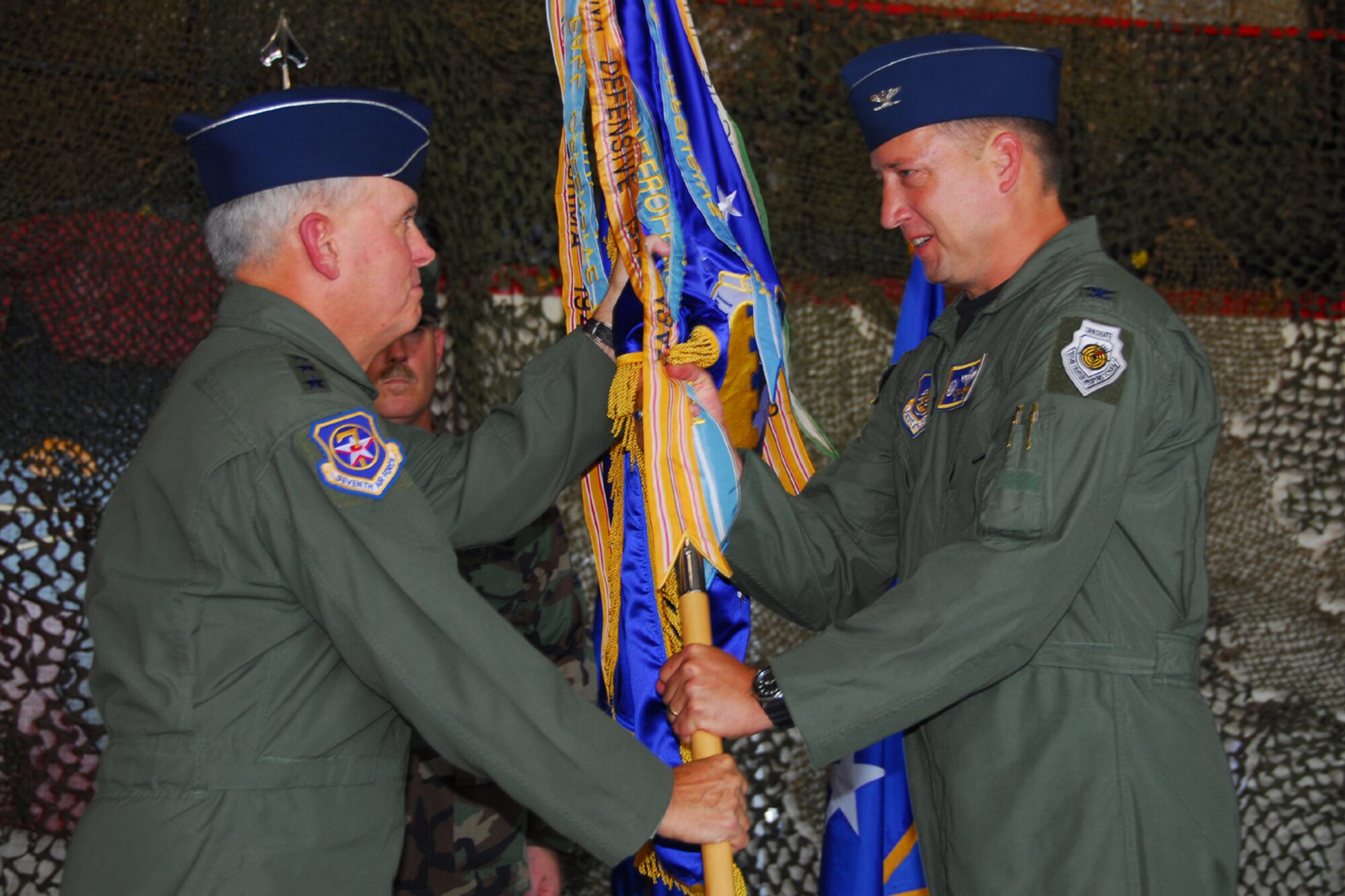 OSAN AIR BASE, Republic of Korea -- Lieutenant General Steven G. Wood, Commander 7th Air Force, passes the 51st Fighter Wing guidon to Colonel Jon Norman as he takes over as Commander of the 51st Fighter Wing during the change of command ceremony today.  (U.S. Air Force photo by Airman 1st Class Chad Strohmeyere)