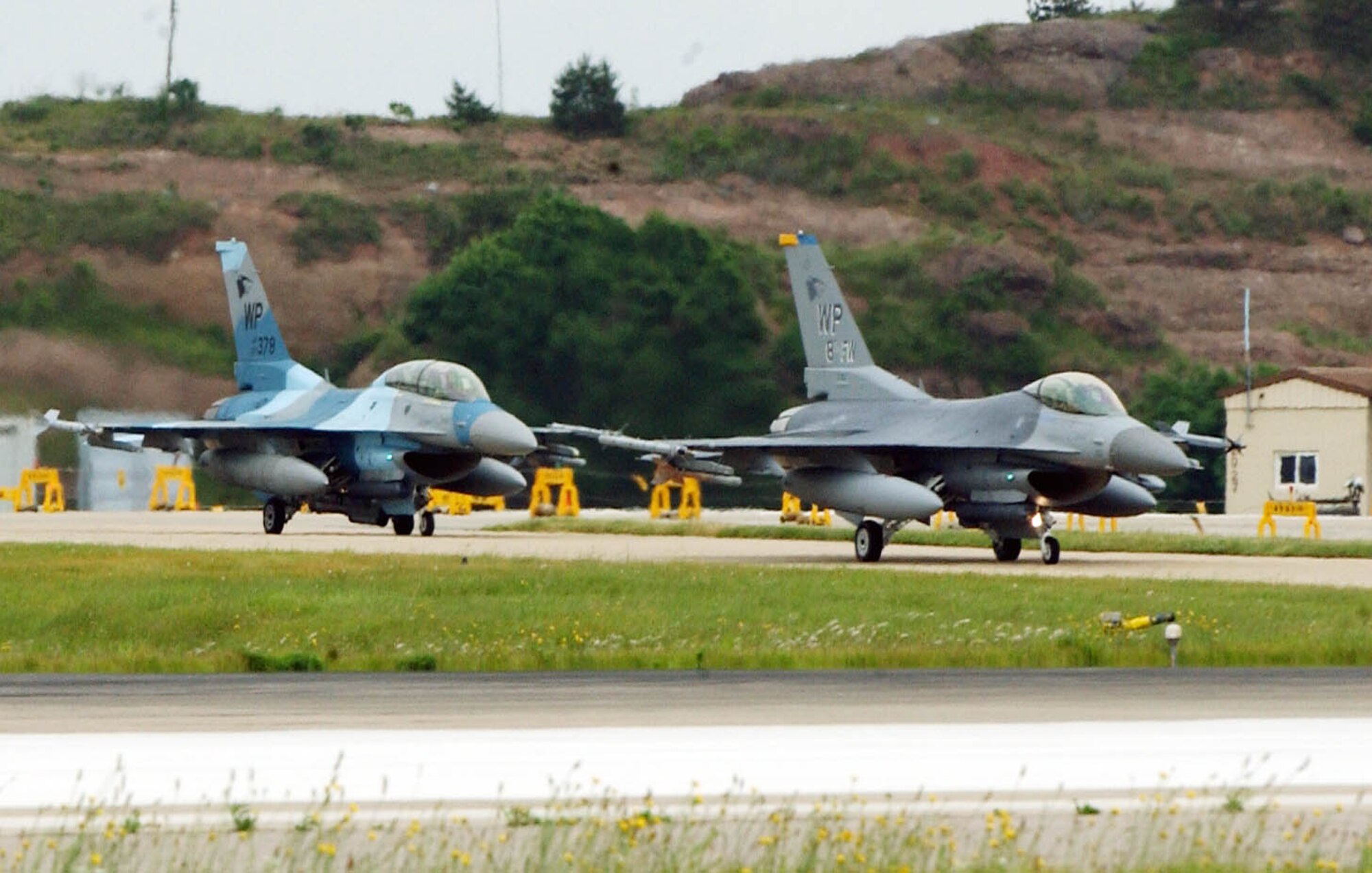 KUNSAN AIR BASE, Republic of Korea -- Pilots from the 8th Fighter Wing standy-by prior to take-off.  Pilots from the 35th and 80th Fighter Squadrons here teamed up with Osan Air Base and Republic of Korea Air Force pilots for the Combined Large Force Excercise, June 14.  The excercise is intended to increase teamwork and communication within the three forces for a more lethal response.  (U.S. Air Force photo/Senior Airman Steven R. Doty)                               