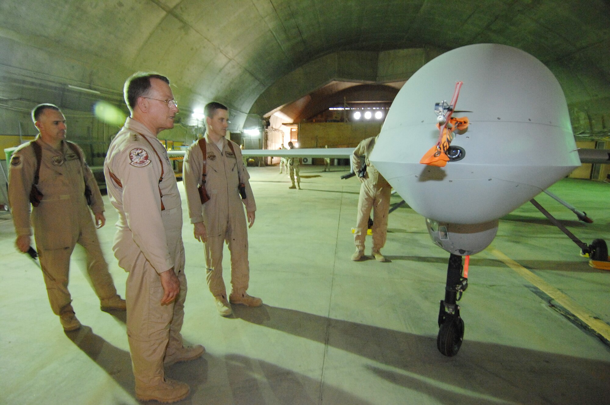 BALAD AIR BASE, Iraq -- Lt. Gen. John Bradley, Air Force Reserve Command commander, looks over a MQ-1B Predator at the 46th Expeditionary Readiness Squadron here. The 46th ERS is part of the 332nd Air Expeditionary Wing. The Wing represents a total force unit with Reservists, Air National Guardsmen and Active Duty Air Force Airmen. General Bradley is visiting Airmen throughout Southwest Asia who are supporting the Global War on Terrorism. U.S. Air Force photo by Tech. Sgt. Rick Sforza (RELEASED)