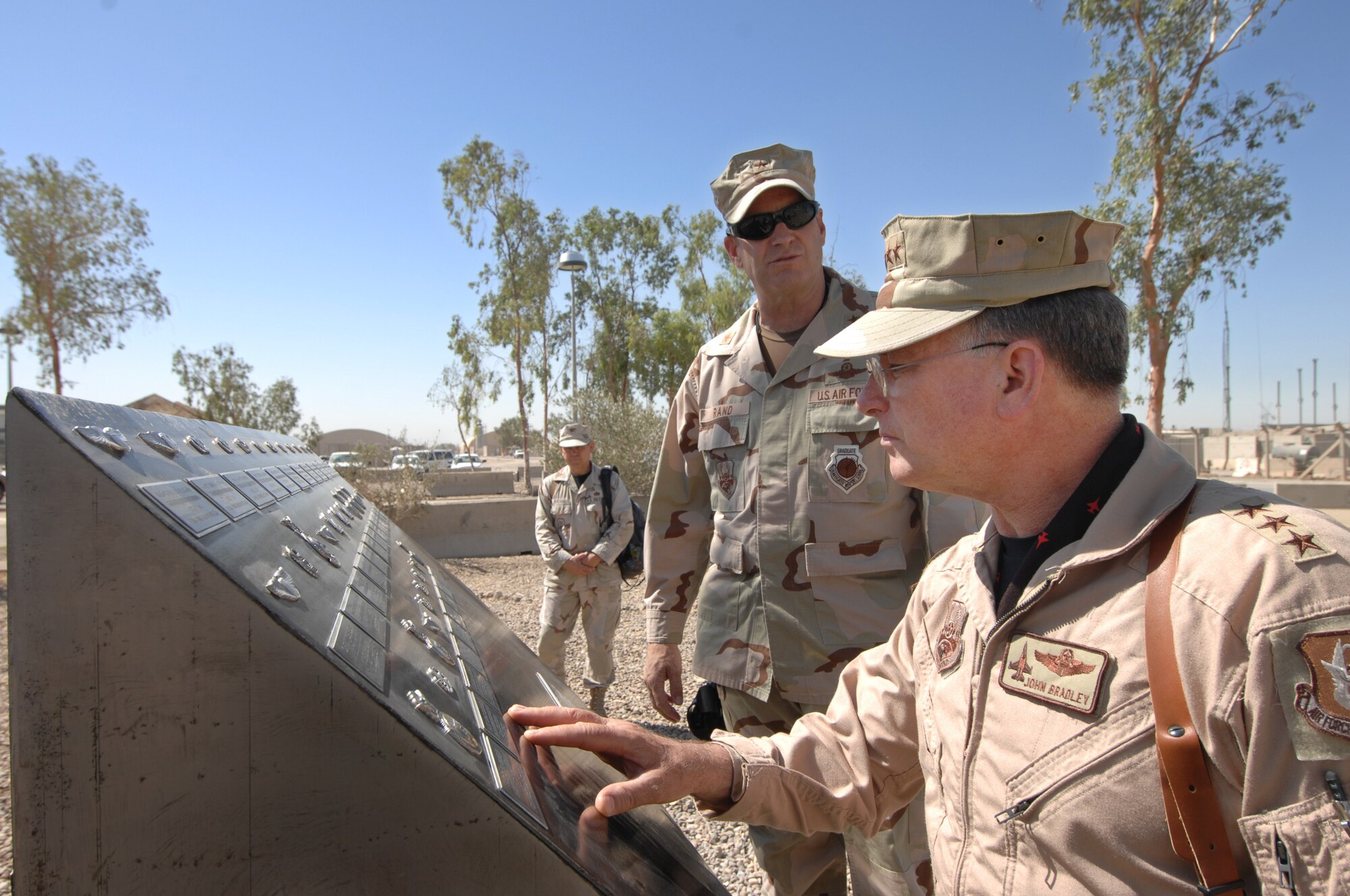 BALAD AIR BASE, Iraq -- Lt. Gen. John Bradley, Air Force Reserve Command commander, right, and Brig. Gen. Robin Rand, 332nd Air Expeditionary Wing commander, visit a memorial for fallen Airmen by the 332nd AEW headquarters building here. The Wing represents a total force unit with Reservists, Air National Guardsmen and Active Duty Air Force Airmen. General Bradley is visiting Airmen throughout Southwest Asia who are supporting the Global War on Terrorism. U.S. Air Force photo by Tech. Sgt. Rick Sforza (RELEASED)