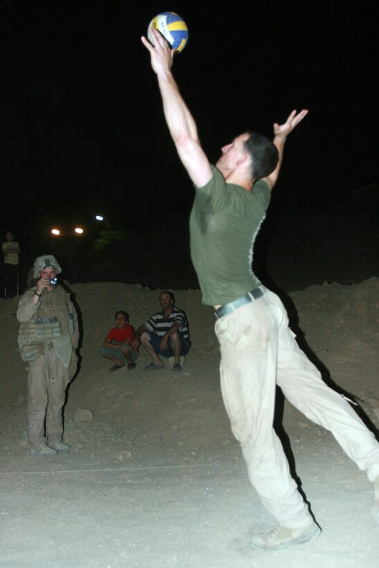 RAWAH, IRAQ – First Lt. Josh L. Schneider, a platoon commander with Company D, 1st Light Armored Reconnaissance Battalion, Regimental Combat Team 2, serves the ball during a volleyball game against local Iraqi civilians. The Marines say the game was a representation of their accomplishments against local insurgency. Official Marine Corps Photo By Cpl. Ryan C. Heiser