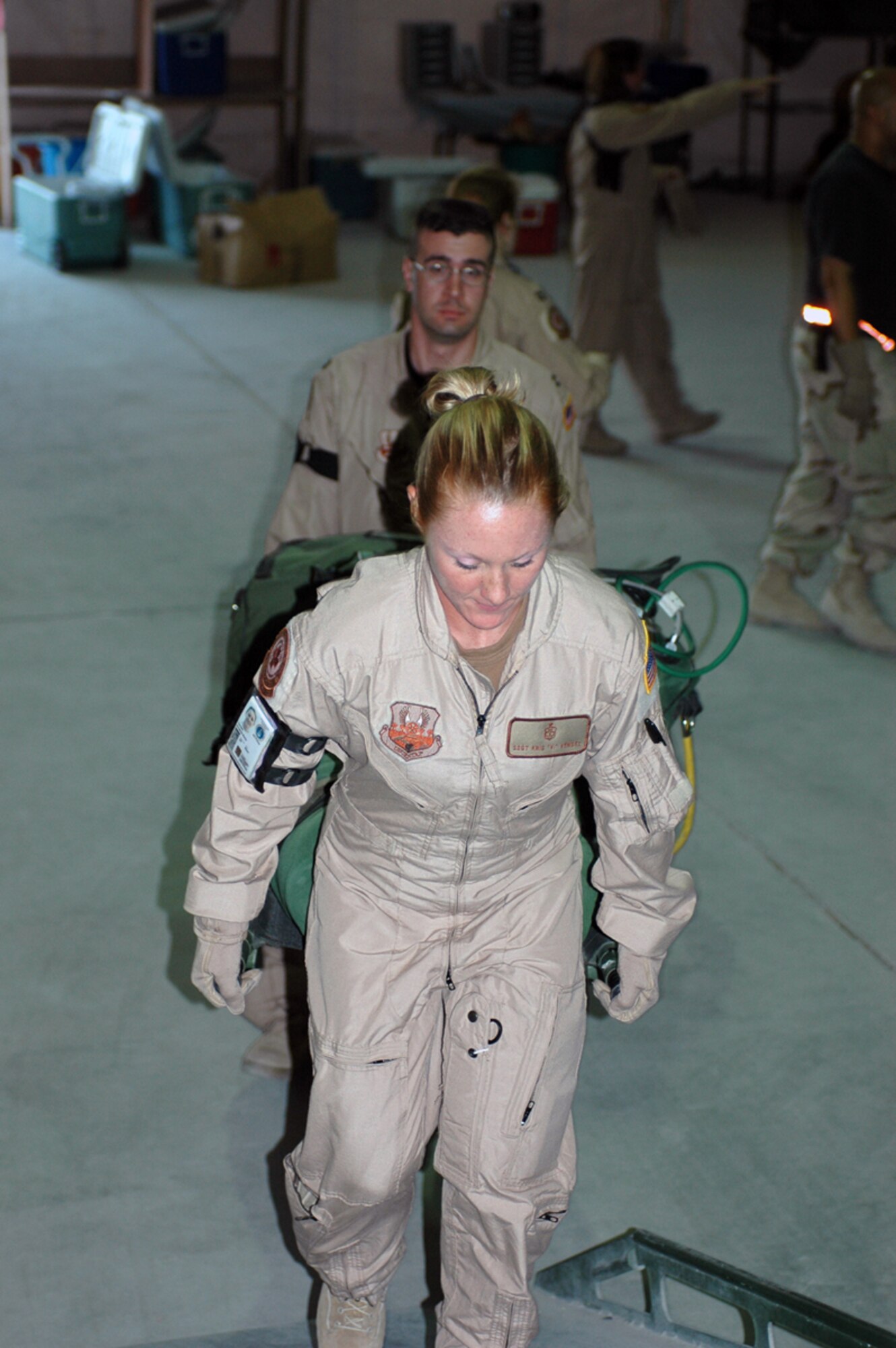 Staff Sgt. Kris Vensel (front) and Capt. Shaun Westphal load a pallet onto a truck to be loaded onto a C-130 aircraft prior to an aeromedical evacuation mission. (U.S. Air Force photo by Staff Sgt. Cassandra Locke)