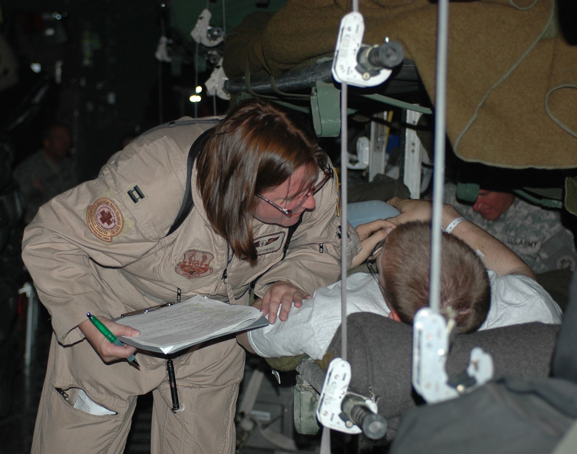 Capt. Reah Downs, 379th Expeditionary Aeromedical Evacuation Squadron, cares for a wounded warrior here. Captain Downs is a flight nurse deployed from Pope AFB, N.C. (U.S. Air Force photo by Staff Sgt. Cassandra Locke)
