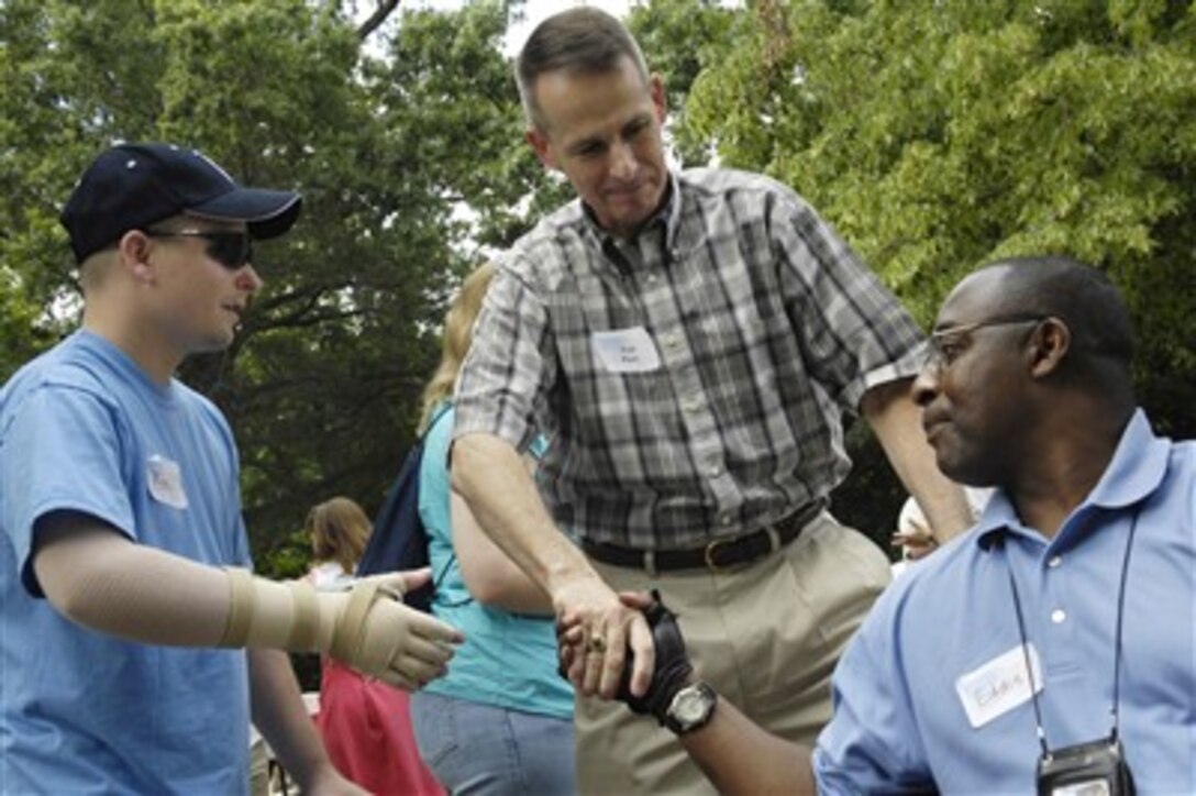 Chairman of the Joint Chiefs of Staff, U.S. Marine Gen. Peter Pace, shakes hands with a wounded servicemember during a picnic in their honor at the Paces' home on Fort Myer, Va., June 16, 2007. 