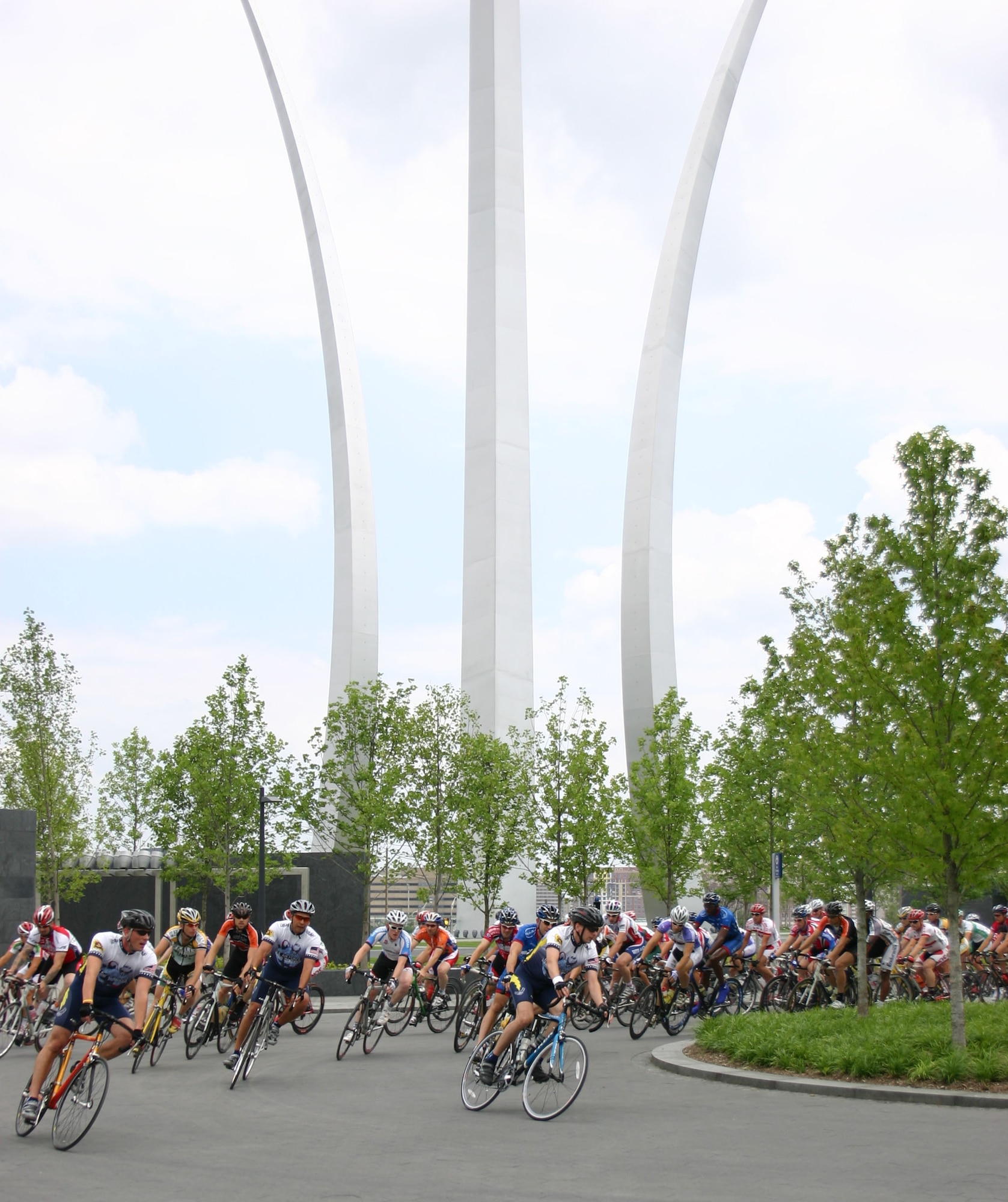 Members of the Air Force cycling team pace the men's pro riders on a parade lap that took them by the Air Force Memorial at Arlington, Va., June 16. The inaugural Crystal City Classic cycling event was presented by the Air Force and plans are in the works for the race to become the Air Force signature sporting event in Washington D.C. (U.S. Air Force photo/Tech. Sgt. Michael Dorsey)