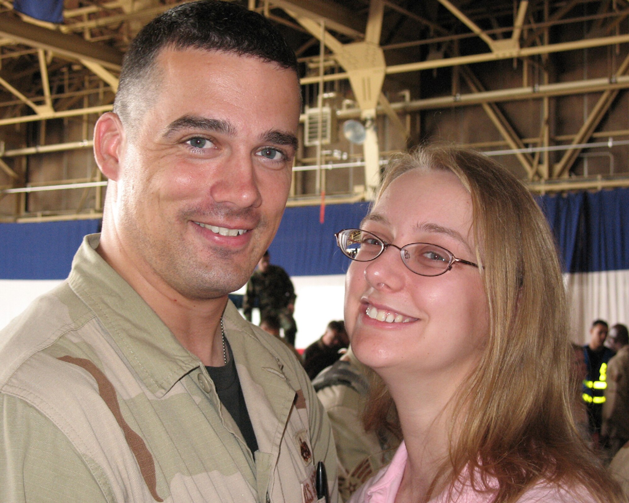 MISAWA AIR BASE, Japan -- Senior Airman Gena Armstrong with her husband Tech Sgt. Barry Armstrong after his return from Iraq to Misawa on June 9th 2007. Sergeant Armstrong, 35th Aircraft Maintenance Squadron, along with14th Fighter Squadron returned later than expected due to weather and mechanical problems. (U.S. Navy Photo By Mass Communications Specialist Seaman Shane Arrington)
