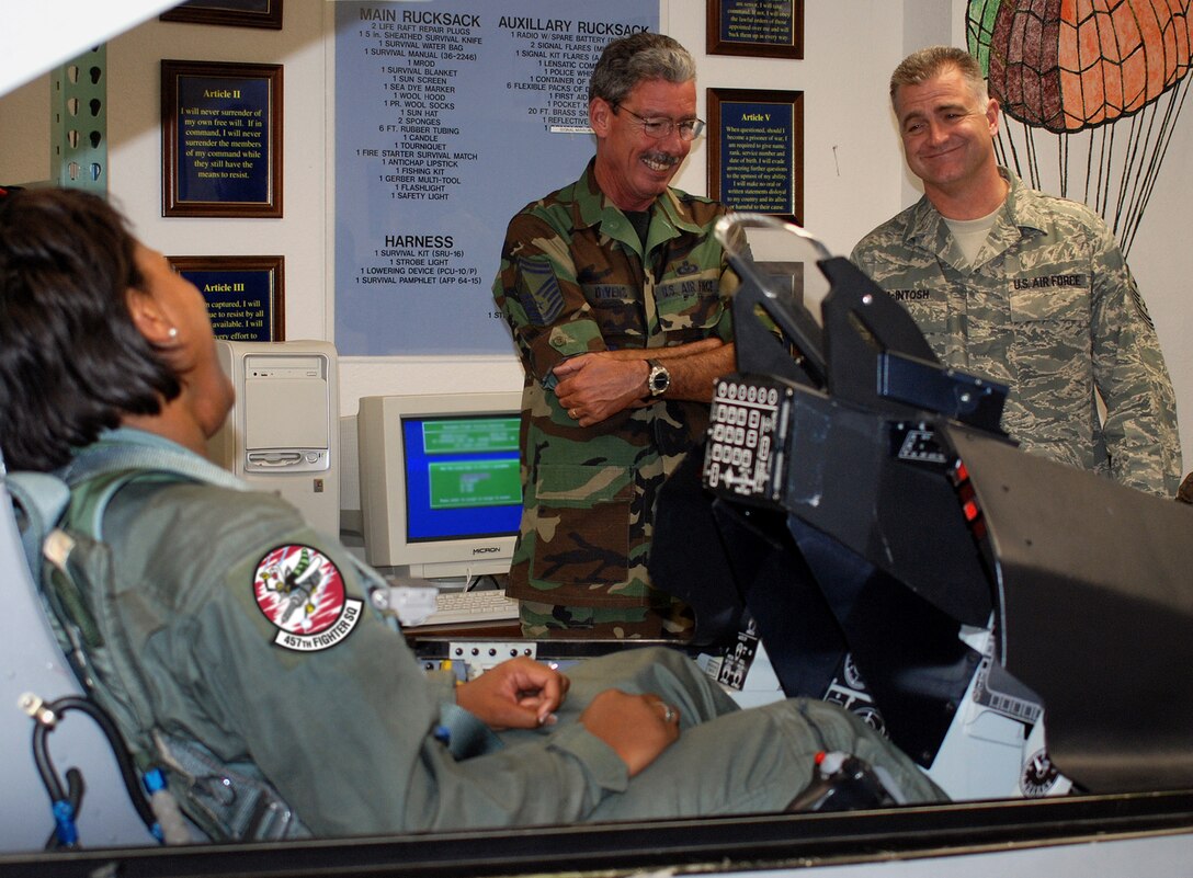 Air Force Reserve Command's Command Chief Master Sgt. Troy McIntosh visited various 301st Fighter Wing facilities during June's Unit Training Assembly. Senior Master Sgt. Larry Owens, 301st Operations Support Flight life support, (center) informs Chief McIntosh about the training Incentive Flight participants receive before taking to the air. Master Sgt. Ellecia Saye, 301st Financial Management, enjoys the company during her instruction phase before flying in one of the unit's F-16s. (U.S. Air Force Photo/ Tech. Sgt. Julie Briden-Garcia)