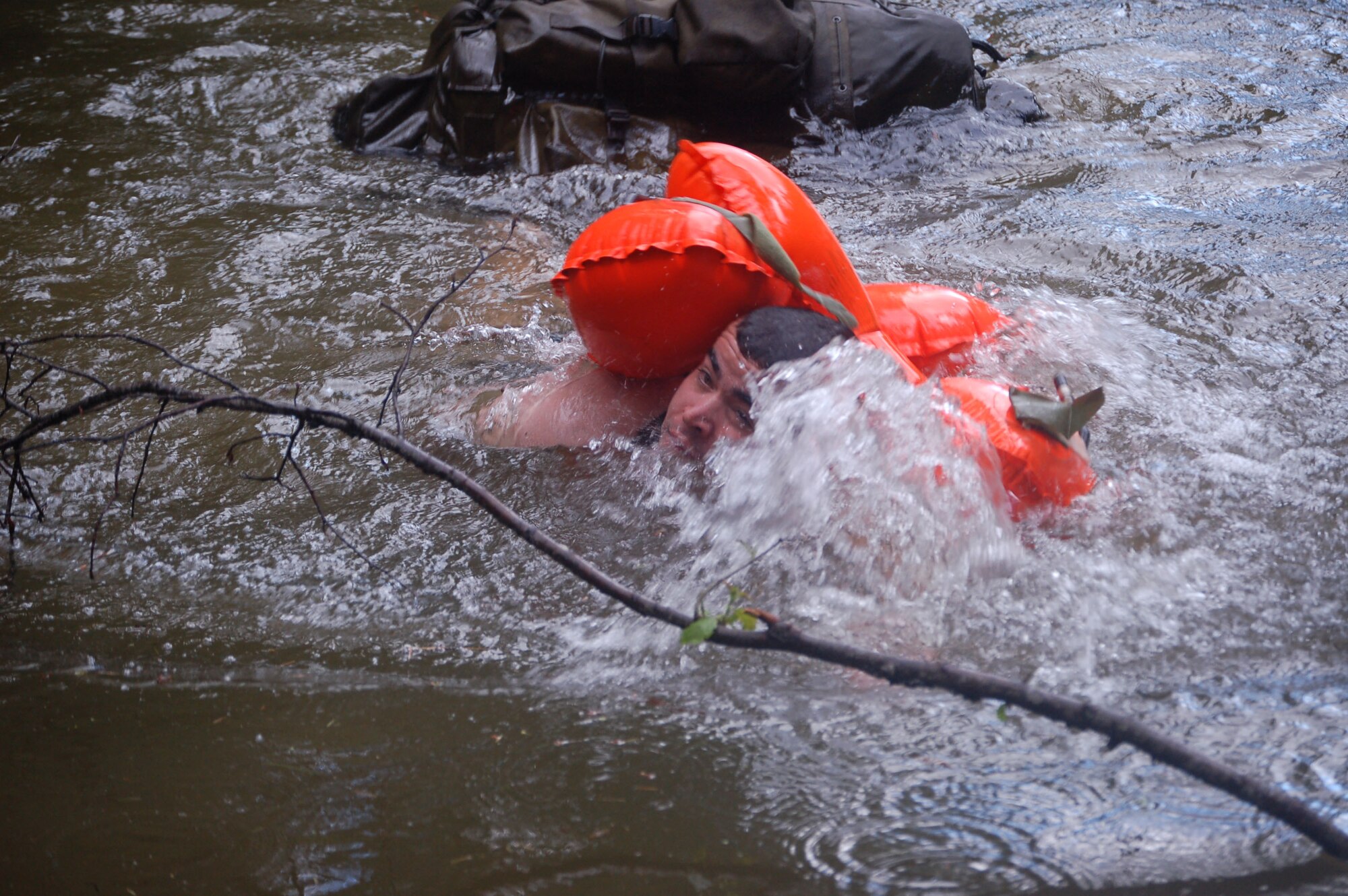 A competitor in the 2007 SERE Challenge approaches the shore after a 300 meter swim through frigid water in the Colville National Forest in Washington.  The SERE Challenge was open to members of the Guardian Angel weapons system: Survival, Evasion, Resistance, Escape specialists; Pararescuemen; and Combat Rescue Officers.  Fifteen two-man teams competed to demonstrate their mastery of survival and combat skills June 11-14 near Fairchild AFB, Wash.  (U.S. Air Force photo by Staff Sgt. Matthew Rosine)

