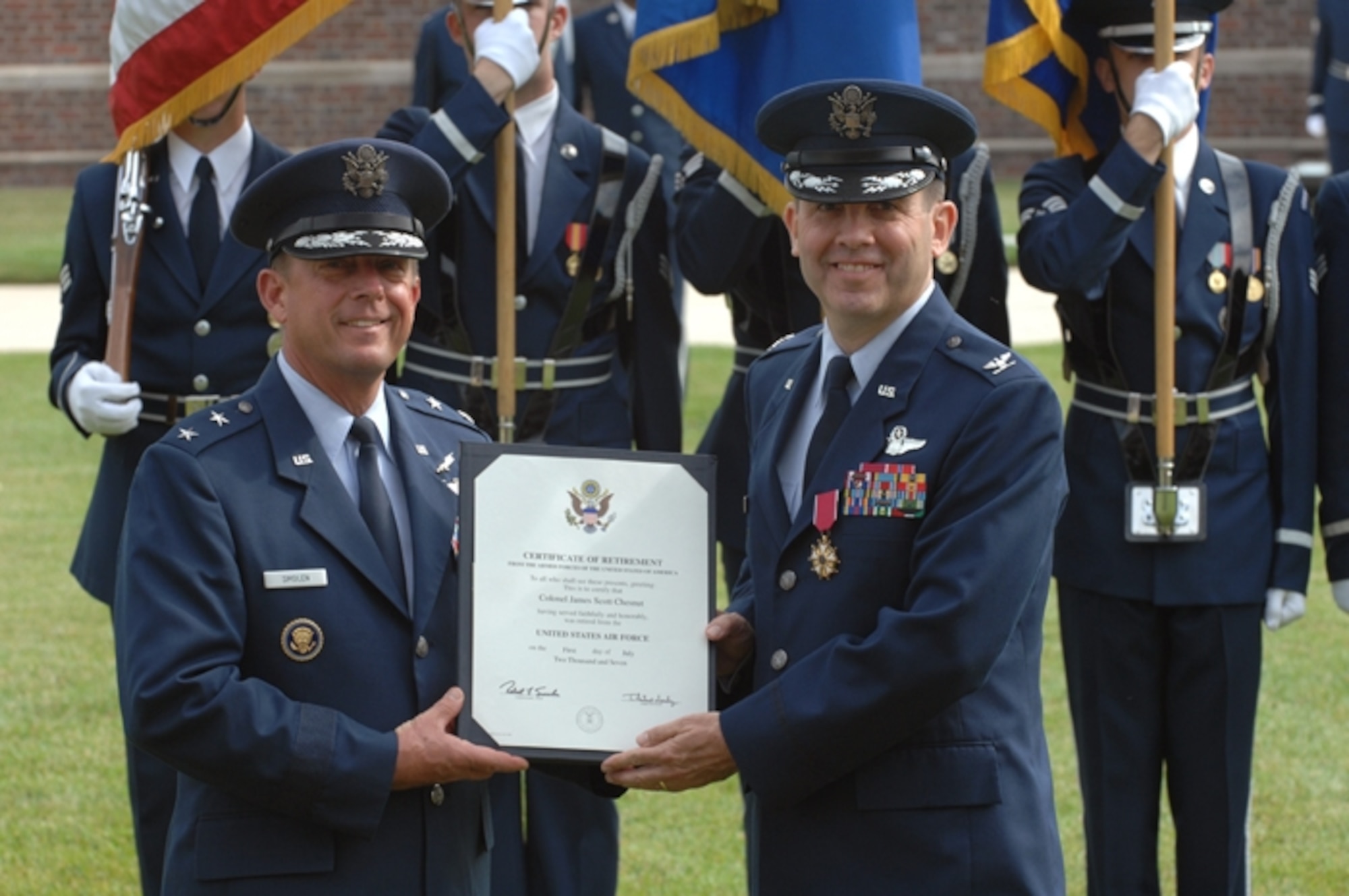 Air Force District of Washington Commanders (left to right) Maj. Gen. Smolen, AFDW Commander and Col. Chesnut, AFDW Vice Commander.  Col. Chesnut accepts an award during his retirement ceremony on June 15 at Bolling AFB, Washington D.C.  (U. S. Air Force photo by Airman 1st Class Timothy Chacon)