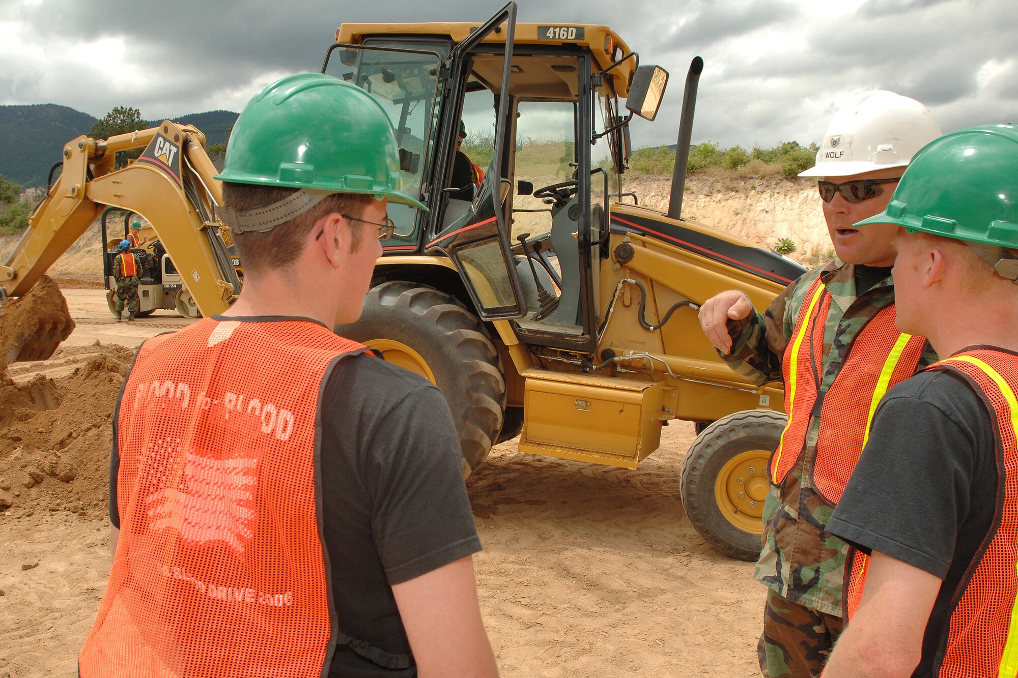 Tech Sgt. Steven D. Wolfe mentors Air Force Academy Cadets 2nd Class Sean Fitzgerald and Sean Houseworth on the proper use of a back hoe during the Field Engineering and Readiness Laboratory course at the Academy.  The course exposes cadets to several aspects of civil engineering, including heavy equipment operation, steel bridge construction, designing and pouring concrete beams and paving portions of a road.  Sergeant Wolfe is from the 434th Civil Engineer Squadron, Grissom Air Reserve Base, Ind.  (U.S. Air Force photo/Joel Strayer)