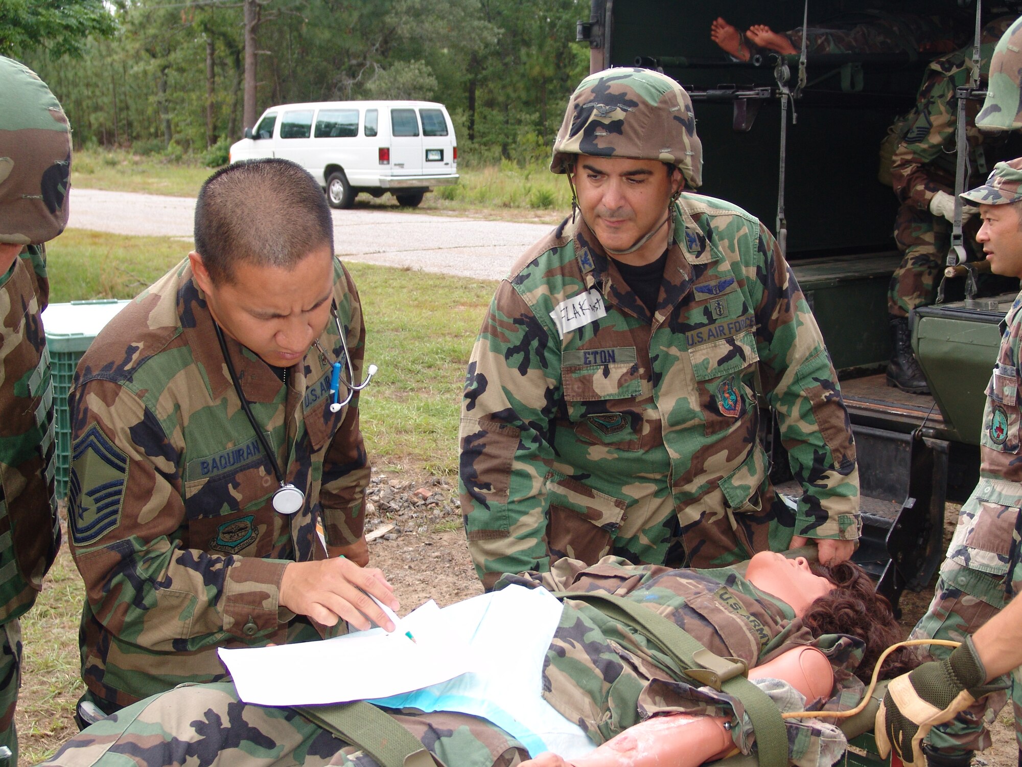 Senior Master Sgt. Frederick Baquiran, 349th Medical Squadron, Travis Air Force Base, Calif., examines a patient chart as Col. Omar Eton, 79th Medical Group emergency room attending physician, Andrews Air Force Base, Md., watches, during Golden Medic 2007 at Fort Gordon, Ga.