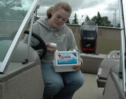 MINOT AIR FORCE BASE, N.D. – Christina Scott, Outdoor Recreation, looks through a first aid kit June 18, to ensure all items are accounted for on boats rented out. (U.S. Air Force photo by Senior Airman Danny Monahan)