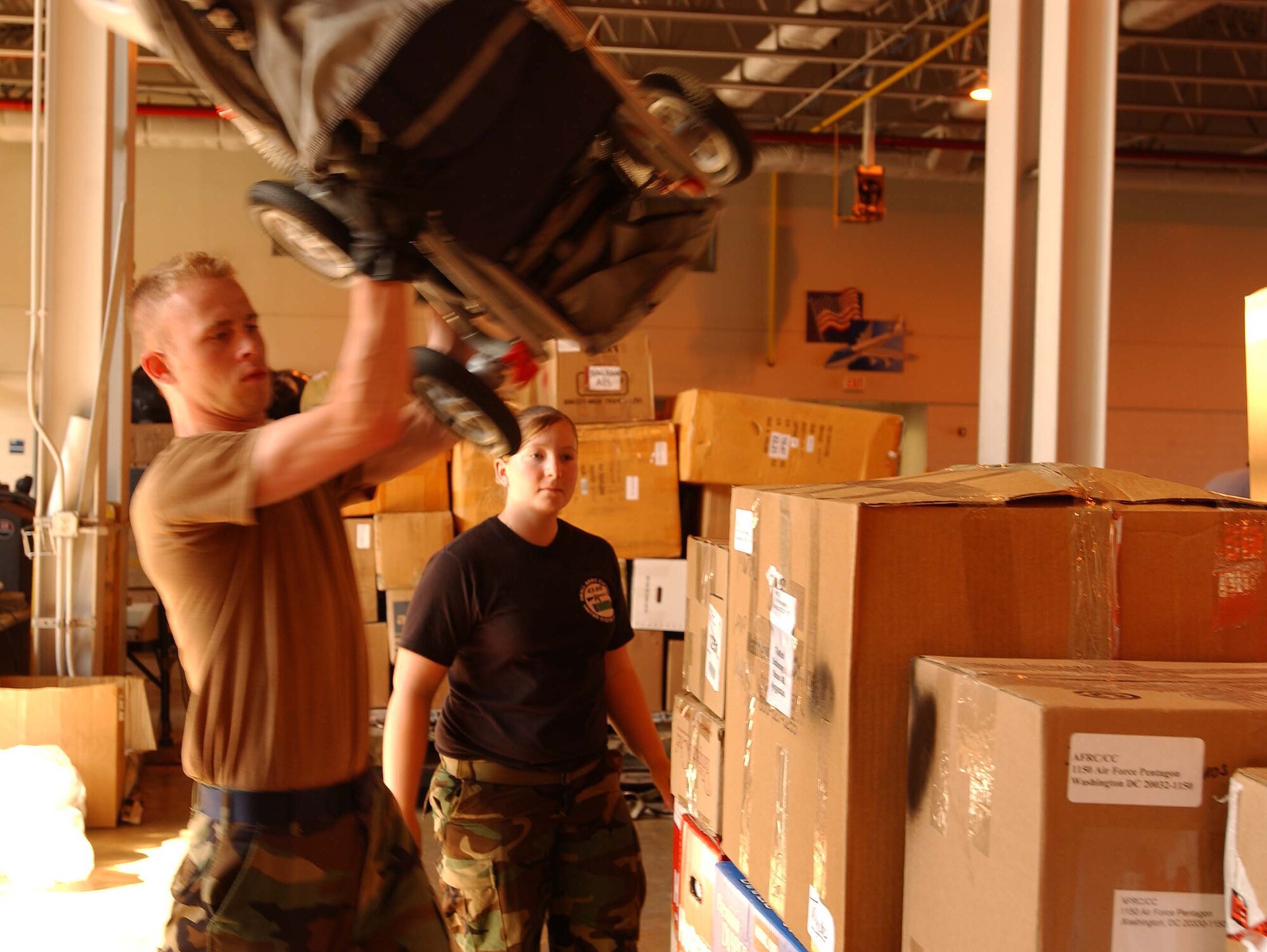 ANDREWS AIR FORCE BASE, Md. -- Senior Airmen Matthew Stidham and Ashley Raley help load toys and supplies onto a cargo pallet June 11 to send to Tok Mok orphanage in Manas, Kyrgyzstan. Members of the 69th Aerial Port Squadron have coordinated with Air Force Reserve Command to load and send five pallets to Bagram and Kabul, Afghanistan, Landstuhl Regional Medical Center, Germany, and Kyrgyzstan. Airman Stidham is a passenger service representative with the 69th APS and Airman Raley is a fire team member with the 459th Security Forces Squadron. Gen. John A. Bradley accompanied some of the cargo on his trip overseas this month. (U.S. Air Force photo/Staff Sgt. Amaani Lyle)