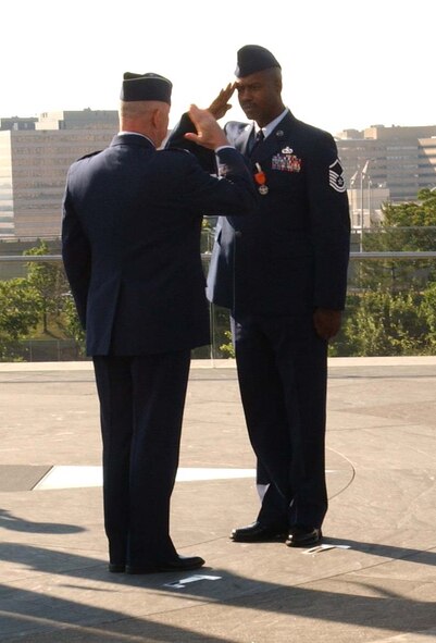 ARLINGTON, Va. -- (Right) U.S. Air Force Reservist Master Sgt. Charlie Peterson salutes Air Force Chief of Staff Gen. T. Michael Moseley, after receiving the Air Force Combat Action Medal during a ceremony June 12. General Moseley presented six Airmen with the medal at the Air Force Memorial. The Airmen were the first in history to receive the decoration. Sergeant Peterson is with the 927th Logistics Readiness Squadron at Selfridge Air National Guard Base, Mich. (U.S. Air Force photo/Staff Sgt. Amaani Lyle)