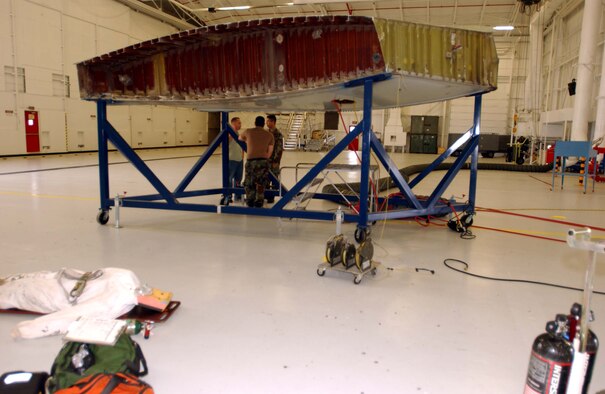 ANDREWS AIR FORCE BASE, Md. -- 459th Maintenance Squadron member Tech. Sgt. Grover McSwain, Staff Sgt. Daniel Garced and Senior Airman James Gomez prepare for a fuel cell extraction exercise June 4. The structure is a simulated portion of a KC-135 aircraft wing. (U.S. Air Force photo/Staff Sgt. Amaani Lyle)