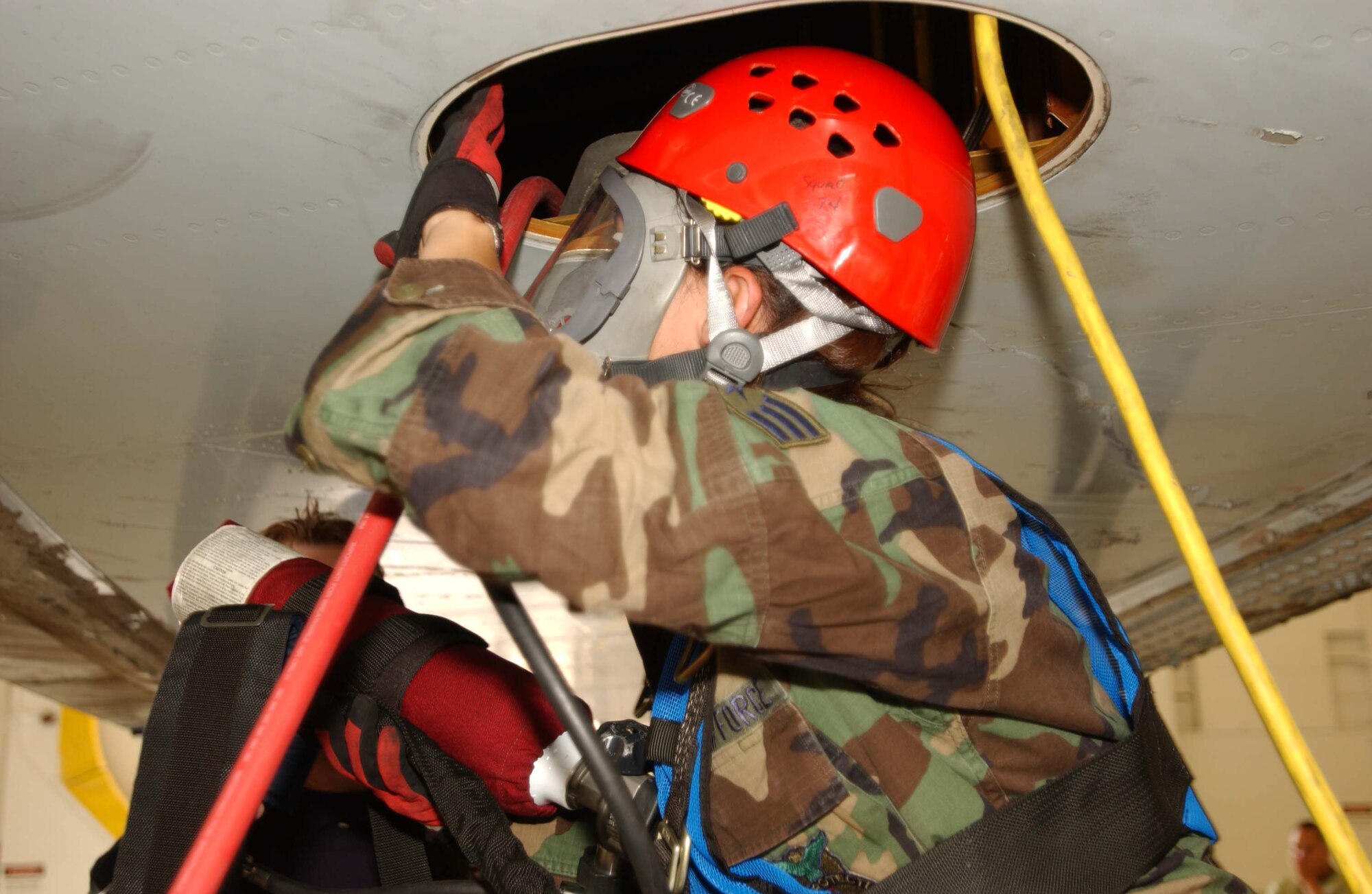 ANDREWS AIR FORCE BASE, Md. -- Senior Airman Jenna Deanda, 316th Civil Engineer Squadron fire protection flight firefighter, makes entry into the fuel cell for extraction June 4. (U..S Air Force photo/Staff Sgt. Amaani Lyle)
