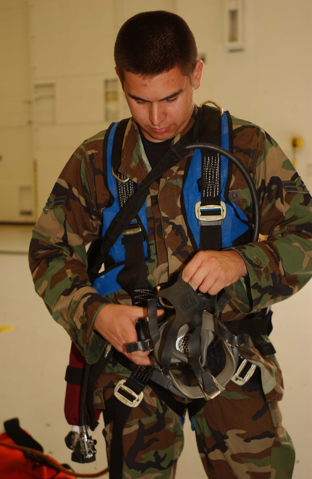ANDREWS AIR FORCE BASE, Md. -- Airman 1st Class Ryan Lemmer, 316th Civil Engineer Squadron fire protection flight firefighter, dons a rescue harness and supplied air respirator to make entry into the fuel cell June 4. (U.S. Air Force photo/Staff Sgt. Amaani Lyle)

