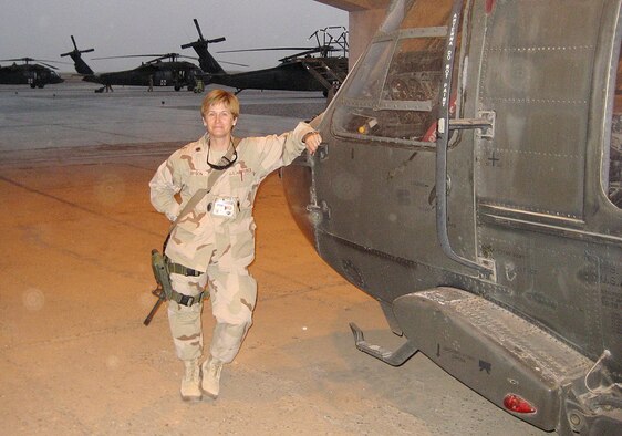 Major Lisa Davison, 14th Medical Operations Squadron, takes a break to pose with a chopper during her deployment in Iraq. Major Davison is a Mental Health Nurse at the Combat Stress Control Detachment 732nd Expeditionary Support Squadron in LSA Adder, Iraq. (U.S. Air Force Photo)
