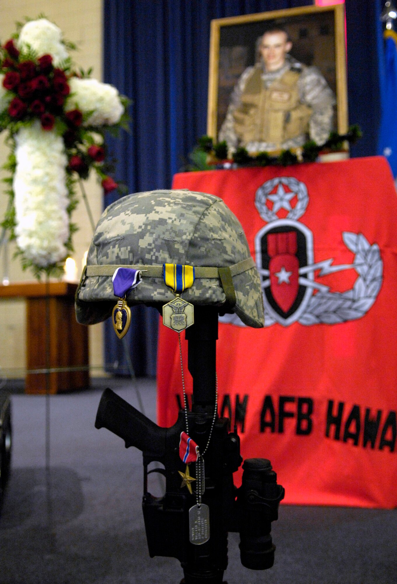 A tribute is displayed during a memorial service honoring Senior Airman William Newman at the base chapel June 13 at Hickam Air Force Base, Hawaii. Airman Newman, an explosive ordnance disposal technician assigned to the 15th Civil Engineer Squadron, was killed June 7 by an improvised explosive device, which detonated while he was supporting Army and Iraqi security forces near Mishna, Iraq. (U.S. Air Force photo/Tech. Sgt. Shane A. Cuomo)
