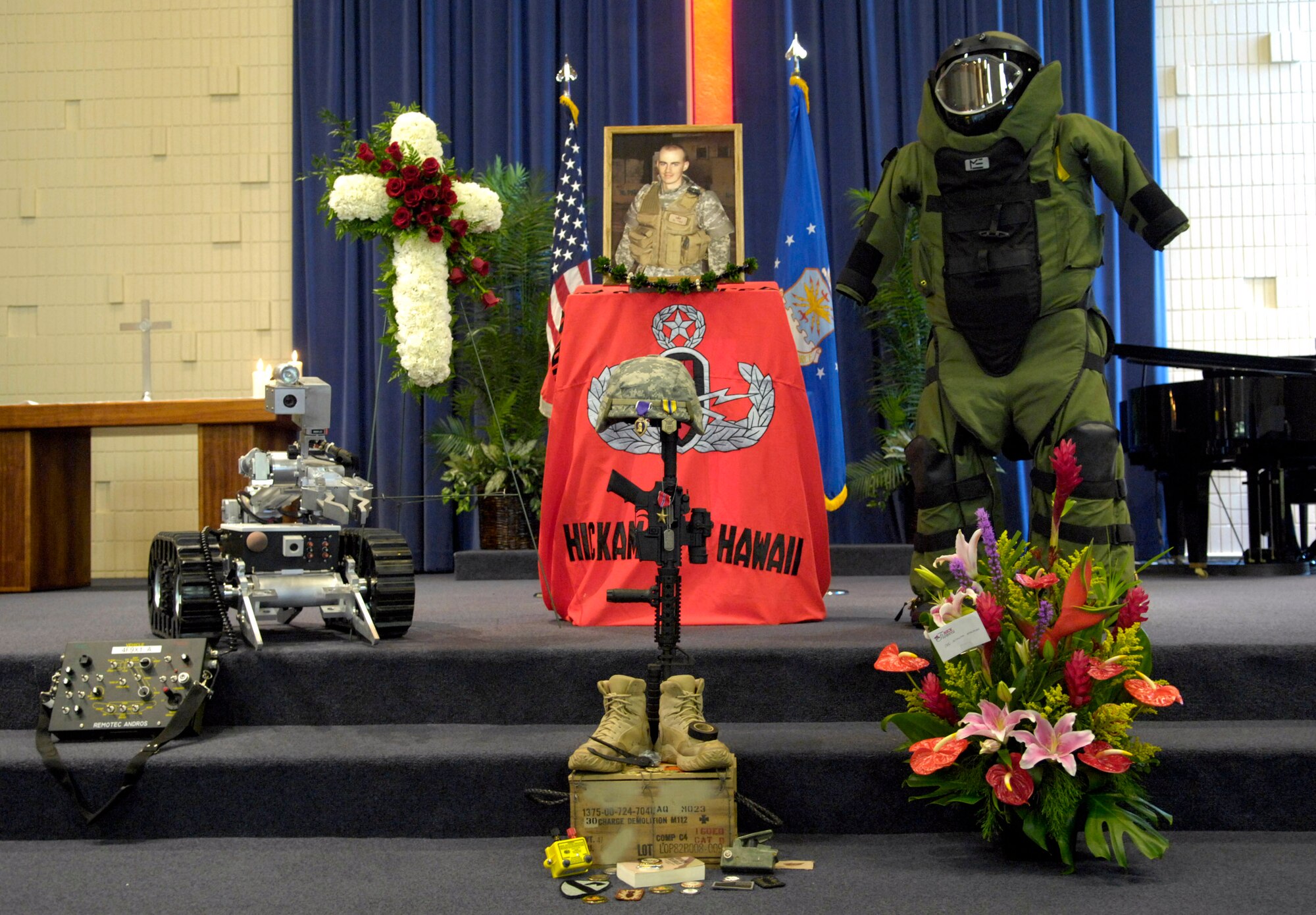 A tribute is displayed during a memorial service honoring Senior Airman William Newman at the base chapel June 13 at Hickam Air Force Base, Hawaii. Airman Newman, an explosive ordnance disposal technician assigned to the 15th Civil Engineer Squadron, was killed June 7 by an improvised explosive device, which detonated while he was supporting Army and Iraqi security forces near Mishna, Iraq. (U.S. Air Force photo/Tech. Sgt. Shane A. Cuomo)
