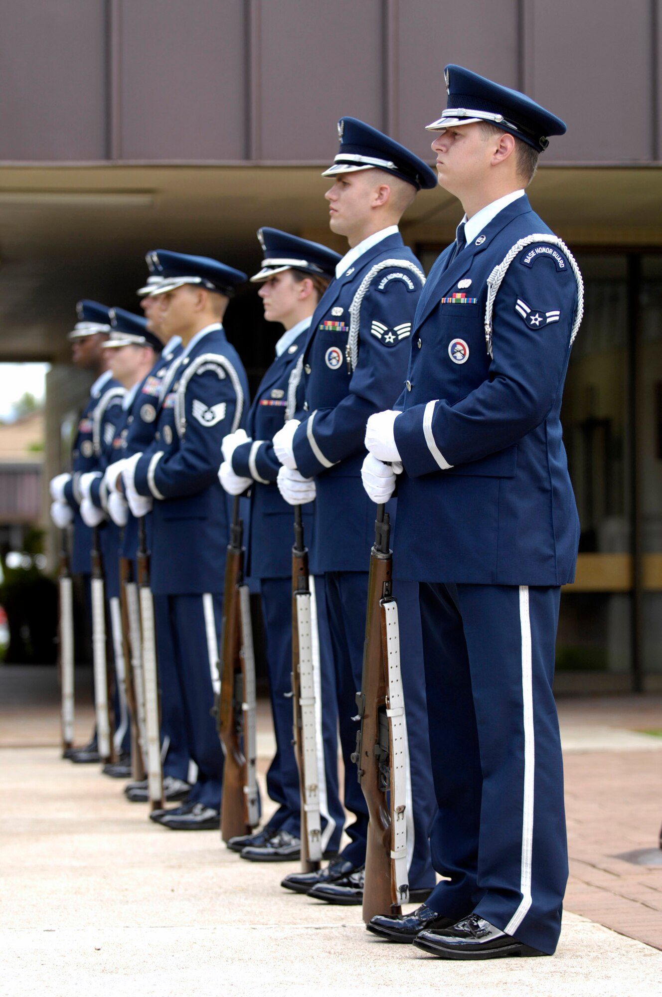 Members of the Honor Guard wait to fire a 21-gun salute during a memorial service honoring Senior Airman William Newman at the base chapel June 13 at Hickam Air Force Base, Hawaii. Airman Newman, an explosive ordnance disposal technician assigned to the 15th Civil Engineer Squadron, was killed June 7 by an improvised explosive device, which detonated while he was supporting Army and Iraqi security forces near Mishna, Iraq. (U.S. Air Force photo/Tech. Sgt. Shane A. Cuomo) 