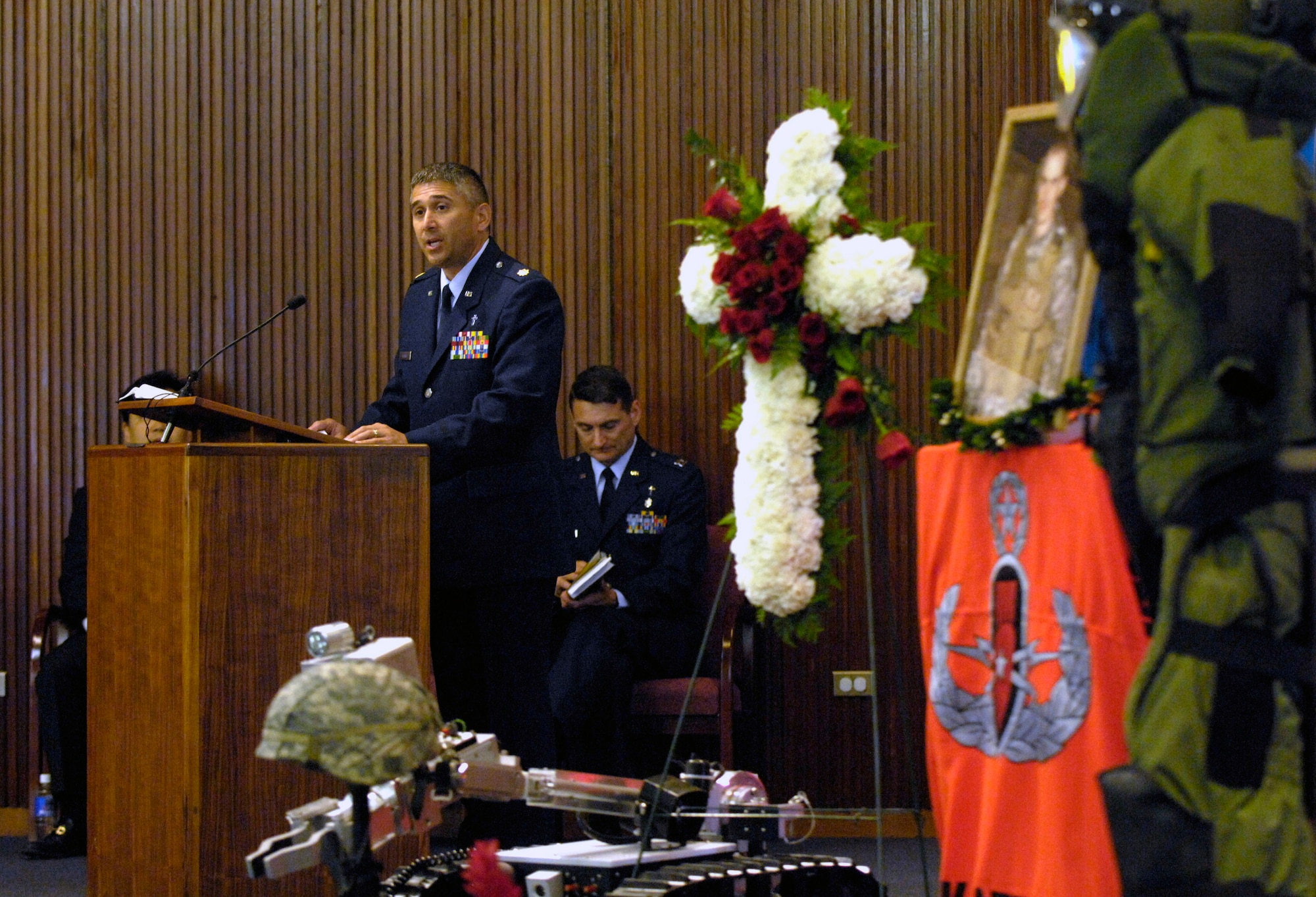 Chaplain (Maj.) Dave DePinho reads the scripture during a memorial service honoring Senior Airman William Newman at the base chapel June 13 at Hickam Air Force Base, Hawaii. Airman Newman, an explosive ordnance disposal technician assigned to the 15th Civil Engineer Squadron, was killed June 7 by an improvised explosive device, which detonated while he was supporting Army and Iraqi security forces near Mishna, Iraq. Chaplain DePinho is with the 15th Airlift Wing. (U.S. Air Force photo/Tech. Sgt. Shane A. Cuomo)