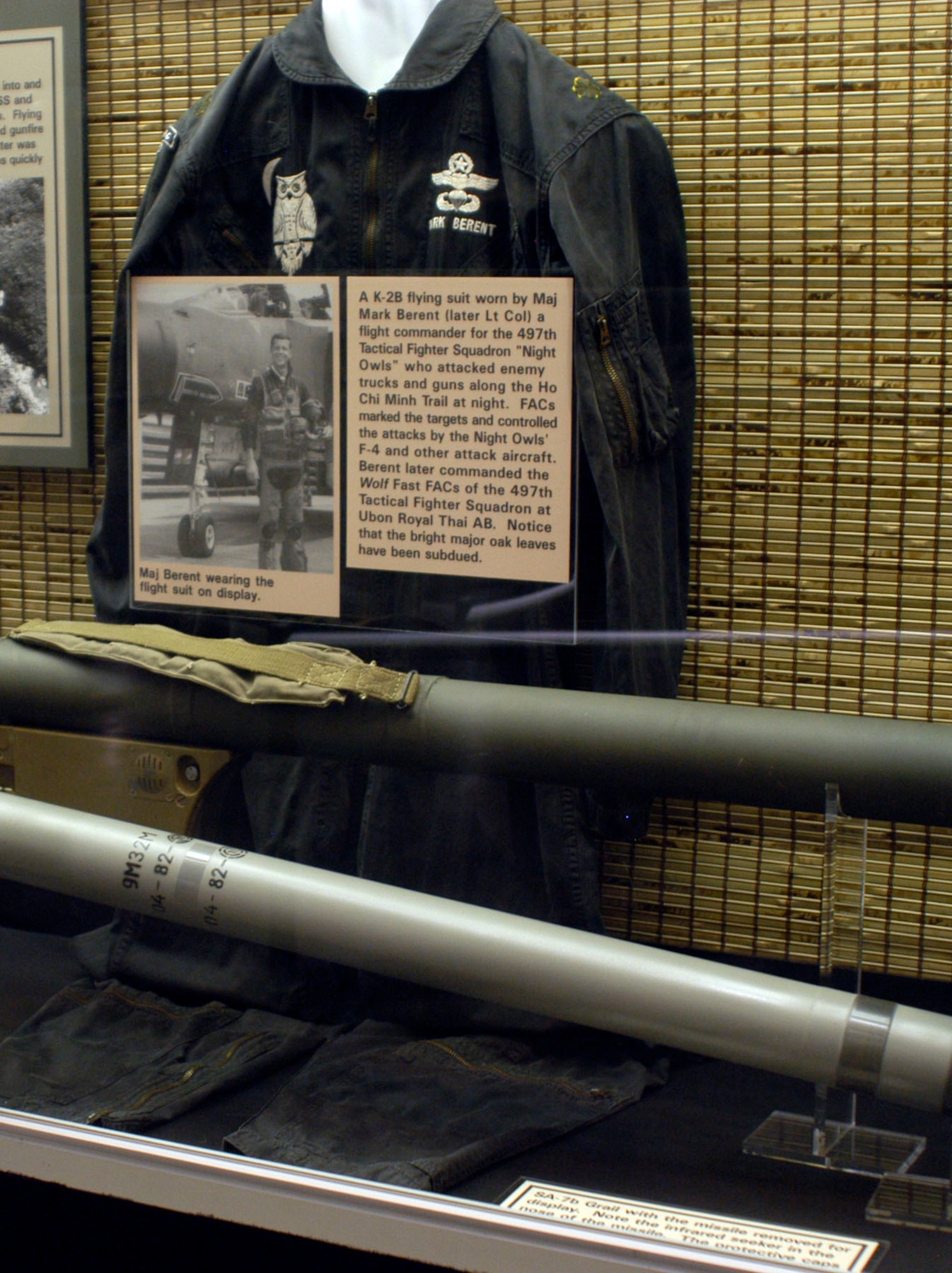 DAYTON, Ohio - A K-2B flying suit worn by Maj. Mark Berent (later Lt. Col.) a flight commander for the 497th Tactical Fighter Squadron “Night Owls” who attacked enemy trucks and guns along the Ho Chi Minh Trail at night. FACs marked the targets and controlled the attacks by the Night Owls’ F-4 and other attack aircraft. Berent later commanded the Wolf Fast FACs of the 497th Tactical Fighter Squadron 8th Tactical Fighter Wing at Ubon Royal Thai AB. Notice that the bright major oak leaves have been subdued. This K-2B flying suit is on display in the Southeast Asia War Gallery at the National Museum of the U.S. Air Force. (U.S. Air Force photo)