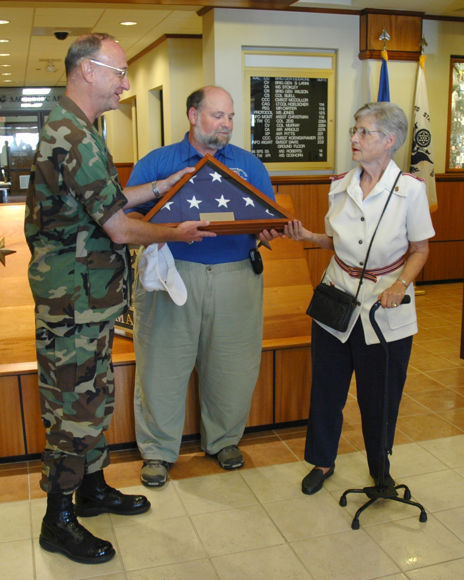 EGLIN AIR FORCE BASE. Fla. -- Col. Joseph Zeis, 46th Test Wing commander, presents an encased flag to Peter and Barbara Straub, the son and widow of retired Lt. Col. Pete Straub. The flag was flown over the Capital in Washington, D.C. and Eglin. Colonel Straub, former president of the Ft. Walton Beach chapter of the Military Order of the World Wars, organized the Massing of the Colors ceremony at the Air Force Armament Museum from 1995 until 2006. Each gathering was held on a day before or after Flag Day for 11 consecutive years. (U.S. Air Force photo by Staff Sgt. Mike Meares)