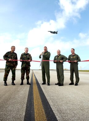 Brig. Gen. Doug Owens, 36th Wing commander, flies the first operational F-16 sortie over Andersen's newly re-opened north runway.  Lt. Col Pete Ridilla, 36th Civil Engineer Squadron commander; Col. Mark Talley, 36th Mission Support Group commander; Col. Joel Westa, 36th Wing vice commander; Col. Damian McCarthy, 36th Operations Group commander; and Lt. Col. Dave Hornyak, 36th Operations Support Squadron commander cut the ribbon marking the official opening of the runway following nearly two years of construction aimed at improving mission capability and safety.