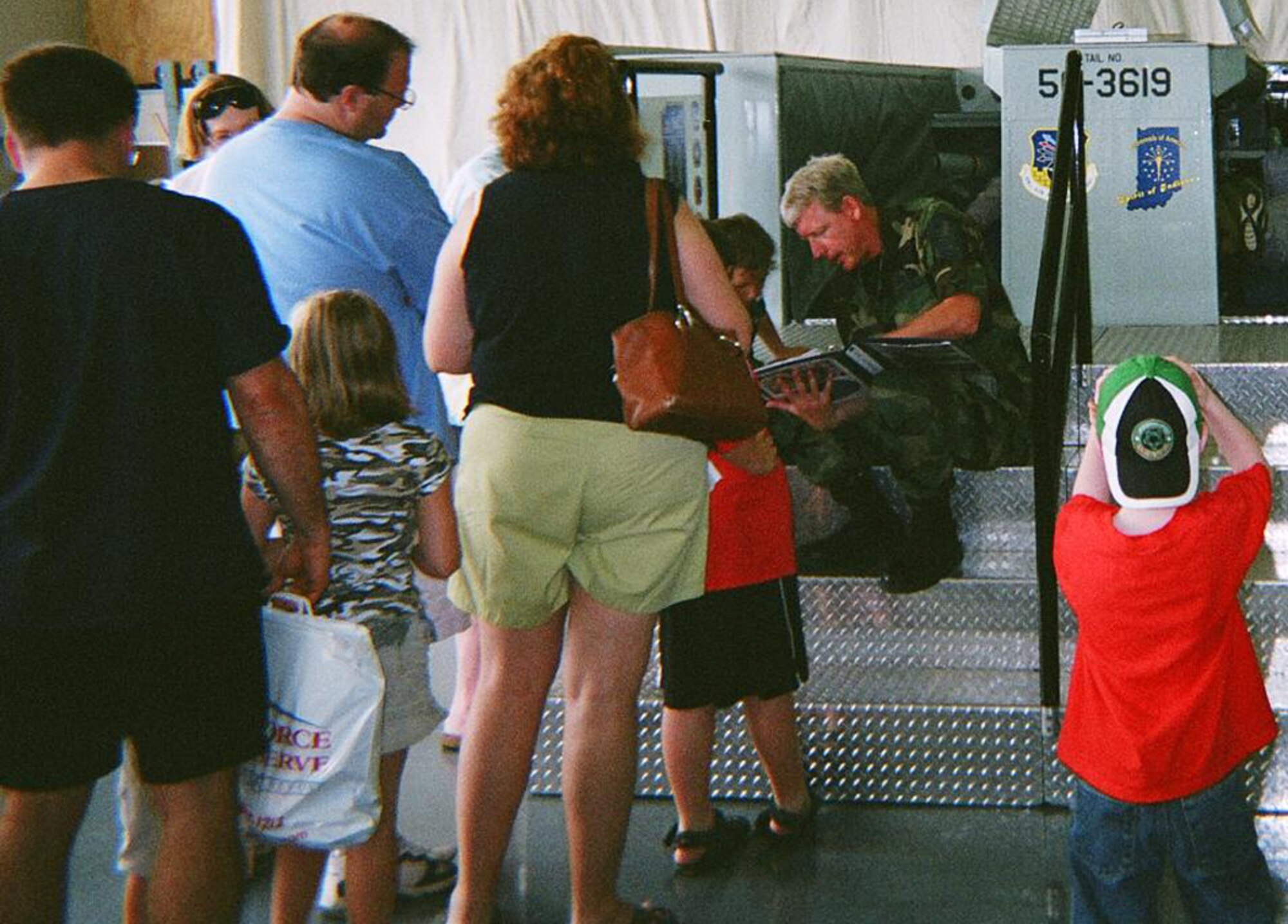 GRISSOM AIR RESERVE BASE, Ind., -- Senior Master Sgt. Richard Scully, 434th Maintenance Group,  talks with visitors to the flight deck and boom pod display during a showing in Bollingbrook, Ill. Grissom members routinely take the displays on the road to open houses, air shows and events to share information about Grissom and the Air Force Reserve Command with audiences who may not otherwise have an opportunity to visit. (U.S. Air Force photo)