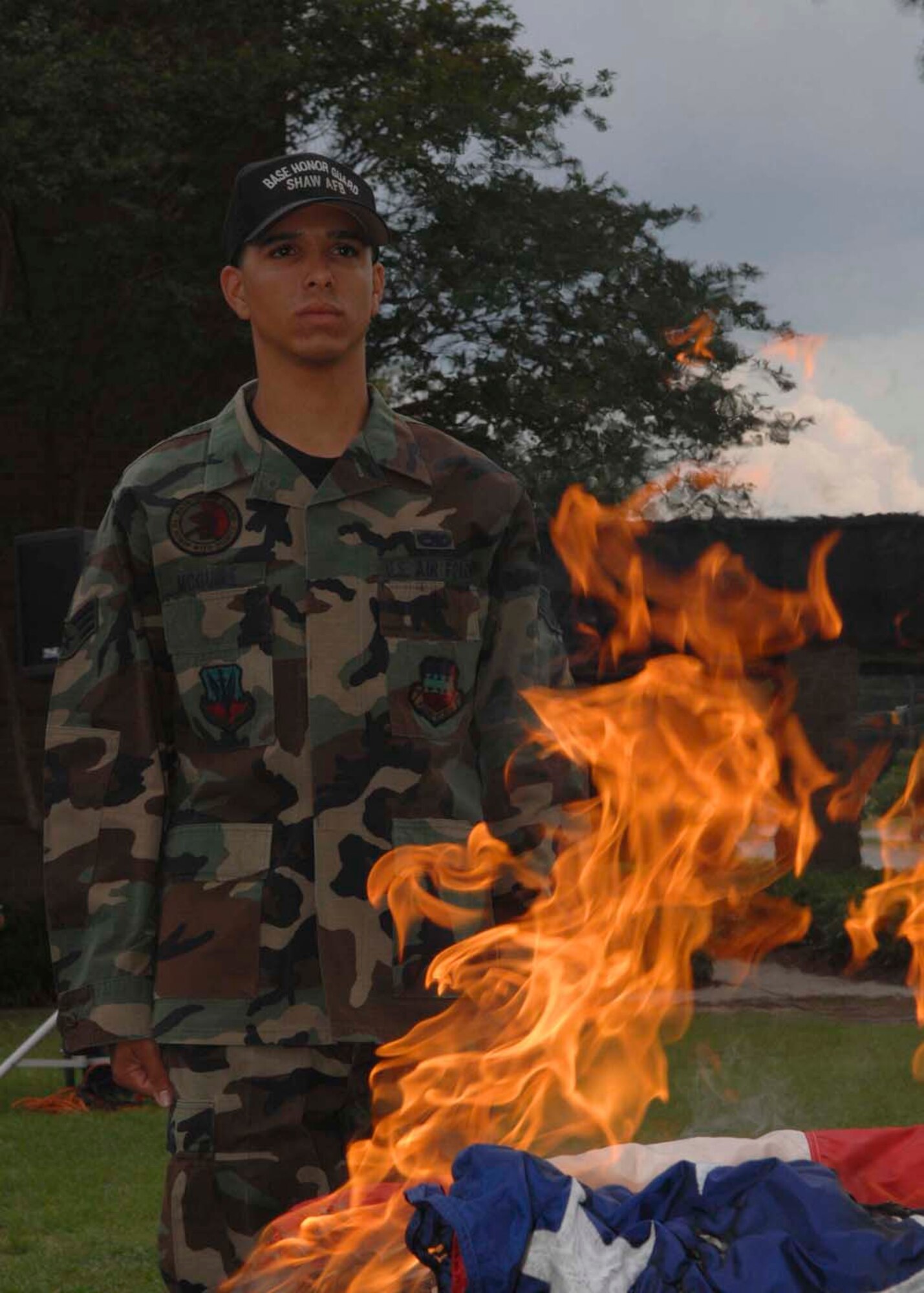 SHAW AIR FORCE BASE, S.C. -- Senior Airman Michael McGuire, 20th Aircraft Maintenance Squadron and Shaw AFB Honor Guard member, stands guard while an unserviceable flag burns during a flag retirement ceremony June 14. The ceremony was part of the Flag Day commemoration events. In accordance with the U.S. Flag Code 36S 176, “the flag, when it is in such condition that it is no longer a fitting emblem of display, should be destroyed in a dignified way. (U.S. Air Force photo/ Airman 1st Class William Coleman)