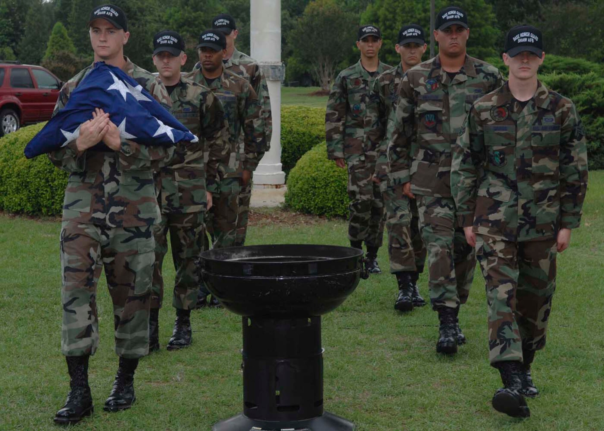 SHAW AIR FORCE BASE, S.C. -- Senior Airman James Ryan, 20th Aircraft Maintenance Squadron, along with other members of the Shaw AFB Honor Guard, carries an unserviceable flag which was retired as part of the Flag Day ceremony June 14. In accordance with the U.S. Flag Code 36S 176, “the flag, when it is in such condition that it is no longer a fitting emblem of display, should be destroyed in a dignified way, preferably by burning". (U.S. Air Force photo/ Airman 1st Class William Coleman)