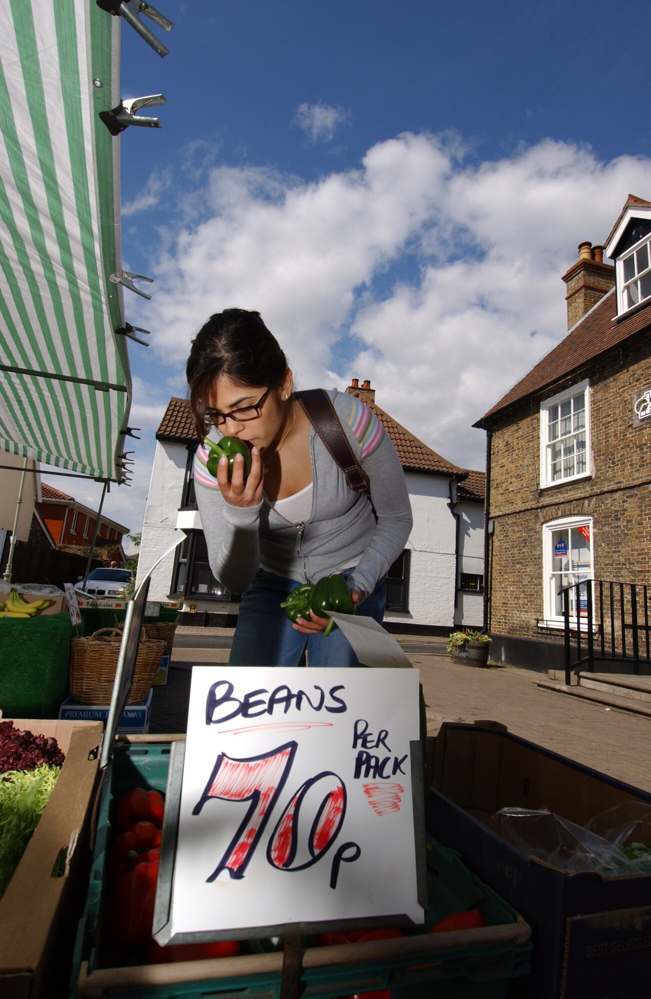 Staff Sgt. Vanessa Bastidas checks out the produce at the Mildenhall market. A vist to the market also offers a chance for people to stop by some of the local shops that offer a variety of deli meats, cheeses, candles and incense. (Air Force photo by Tech. Sgt. Eric Petosky)