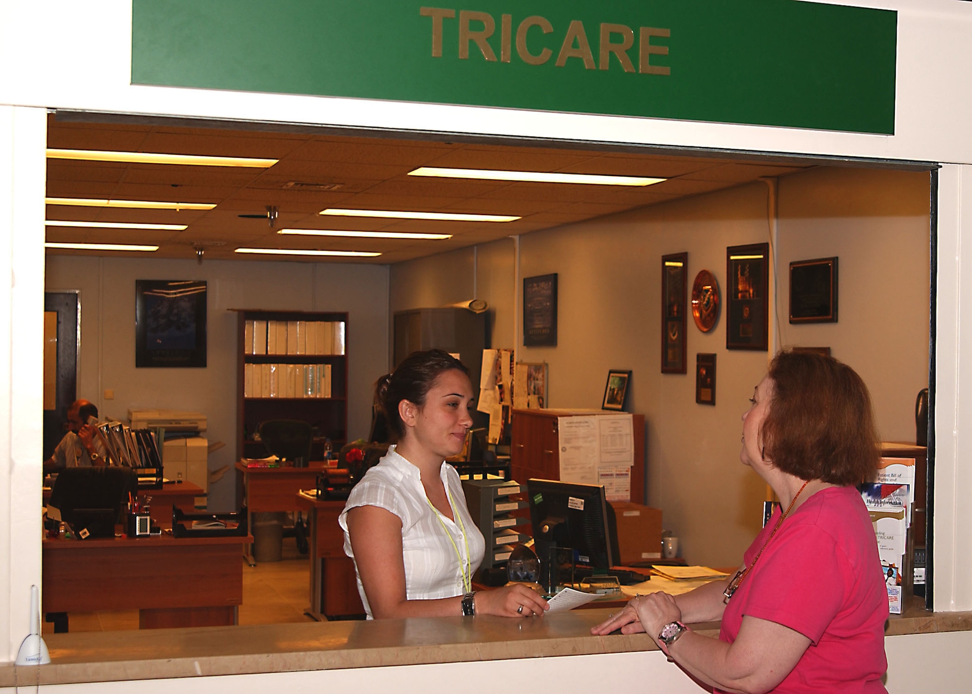 Zeynep Halicilar, 39th Medical Group TRICARE customer service representative, helps answer Lucinda Hawkes questions about a TRICARE application form on 7 June.  (U. S. Air Force photo by Tech. Sgt. Patrick R. Hyde)