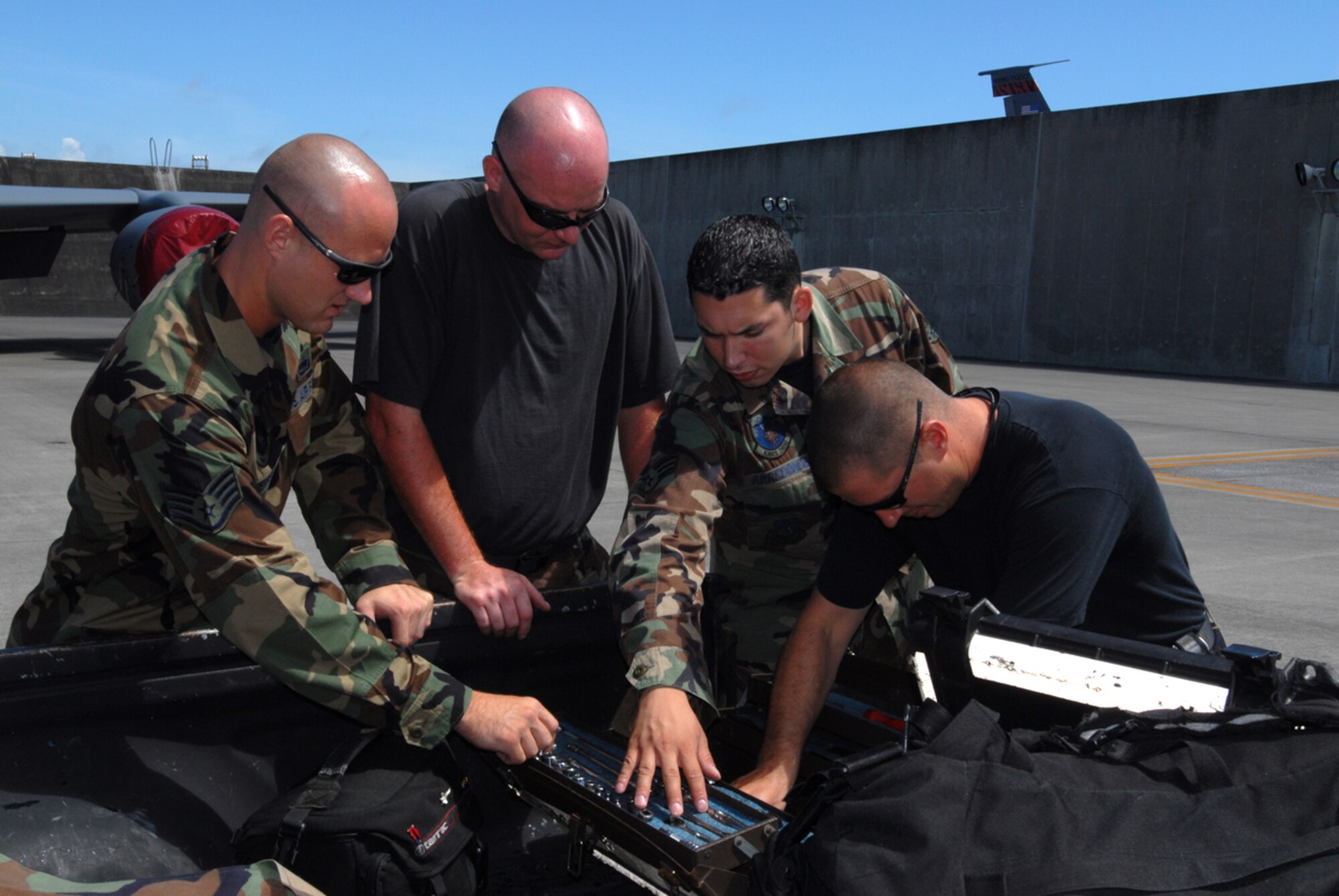 Staff Sgt. Aaron Merrell (left), Tech. Sgt. Robert Spears (left center), Senior Airman Joshua Arredondo (right center), and Tech. Sgt. Bryn Lochman, all from the 718th Air Maintenance Squadron, Kadena Air Base, Japan, inventory their consolidated tool kit after working on a KC-135 aircraft in preparation for the Air Mobility Rodeo July 22-28 at McChord Air Force Base, Wash. Several 18th Wing units have begun practicing for the annual competition that pits teams from around the world. 
(U.S. Air Force/Airman 1st Class Kasey Zickmund)
