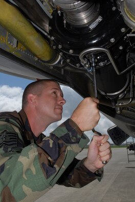 Tech. Sgt. Bryn Lochman, 718th Air Maintenance Squadron, changes the oil on a KC-135 aircraft in preparation for the Air Mobility Rodeo July 22-28 at McChord Air Force Base, Wash. Several wing units have begun practicing for the annual competition that pits teams from around the world. 
(U.S. Air Force/Airman 1st Class Kasey Zickmund)