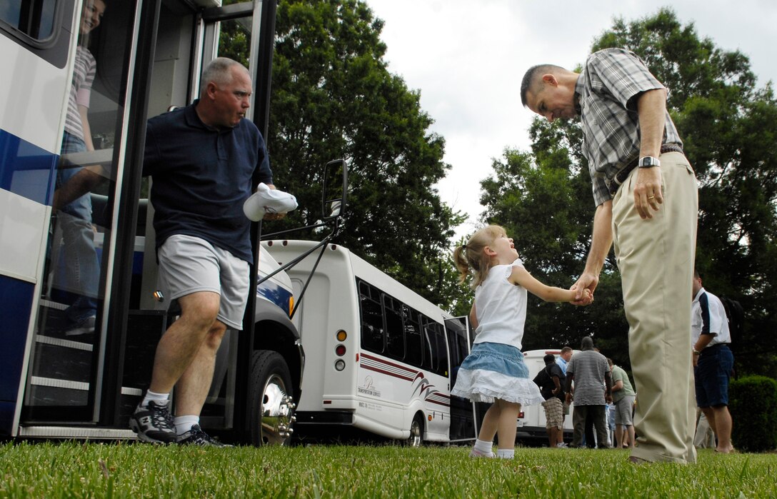Chairman of the Joint Chiefs of Staff, U.S. Marine Gen. Peter Pace, shakes hands with the child of a wounded servicemember as they arrive for a picnic in their honor at the Paces' home on Fort Myer, Va., June 16, 2007. 