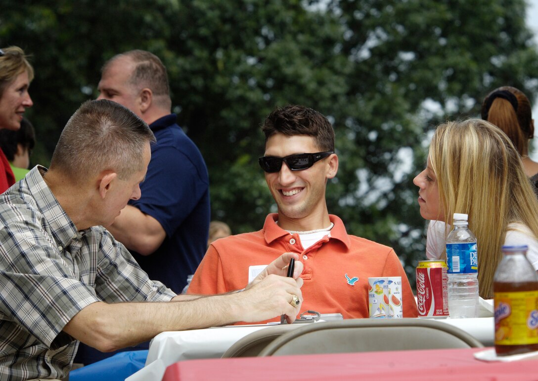 Chairman of the Joint Chiefs of Staff, U.S. Marine Gen. Peter Pace, speaks with a wounded servicemember during a picnic honoring them and their families at the Paces' home on Fort Myer, Va., June 16, 2007. 