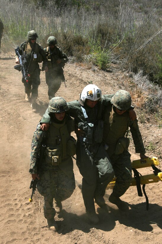 FIRE BASE GLORIA, MARINE CORPS BASE CAMP PENDLETON, Calif. ? Marines with Weapons Company, Battalion Landing Team 1st Battalion, 5th Marine Regiment, 11th Marine Expeditionary Unit, from here, evacuate a wounded pilot during in a Tactical Recovery of Aircraft and Personnel (TRAP) exercise June 14, here. The Marines with the BLT were engaged with a mock AV-8B Harrier II accident and the recovery and evacuation of the pilot. The training was provided by Special Operations Training Group, I Marine Expeditionary Force, from here.
