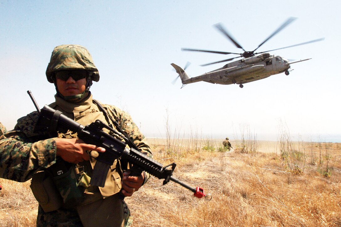 FIRE BASE GLORIA, MARINE CORPS BASE CAMP PENDLETON, Calif. ?A Marine with Weapons Company, Battalion Landing Team 1st Battalion, 5th Marine Regiment, 11th Marine Expeditionary Unit provides security during a Tactical Recovery of Aircraft and Personnel (TRAP) exercise June 14, here. The Marines with the BLT were engaged with a mock AV-8B Harrier II accident and the recovery and evacuation of the pilot. The training was provided by Special Operations Training Group, I Marine Expeditionary Force, from here.