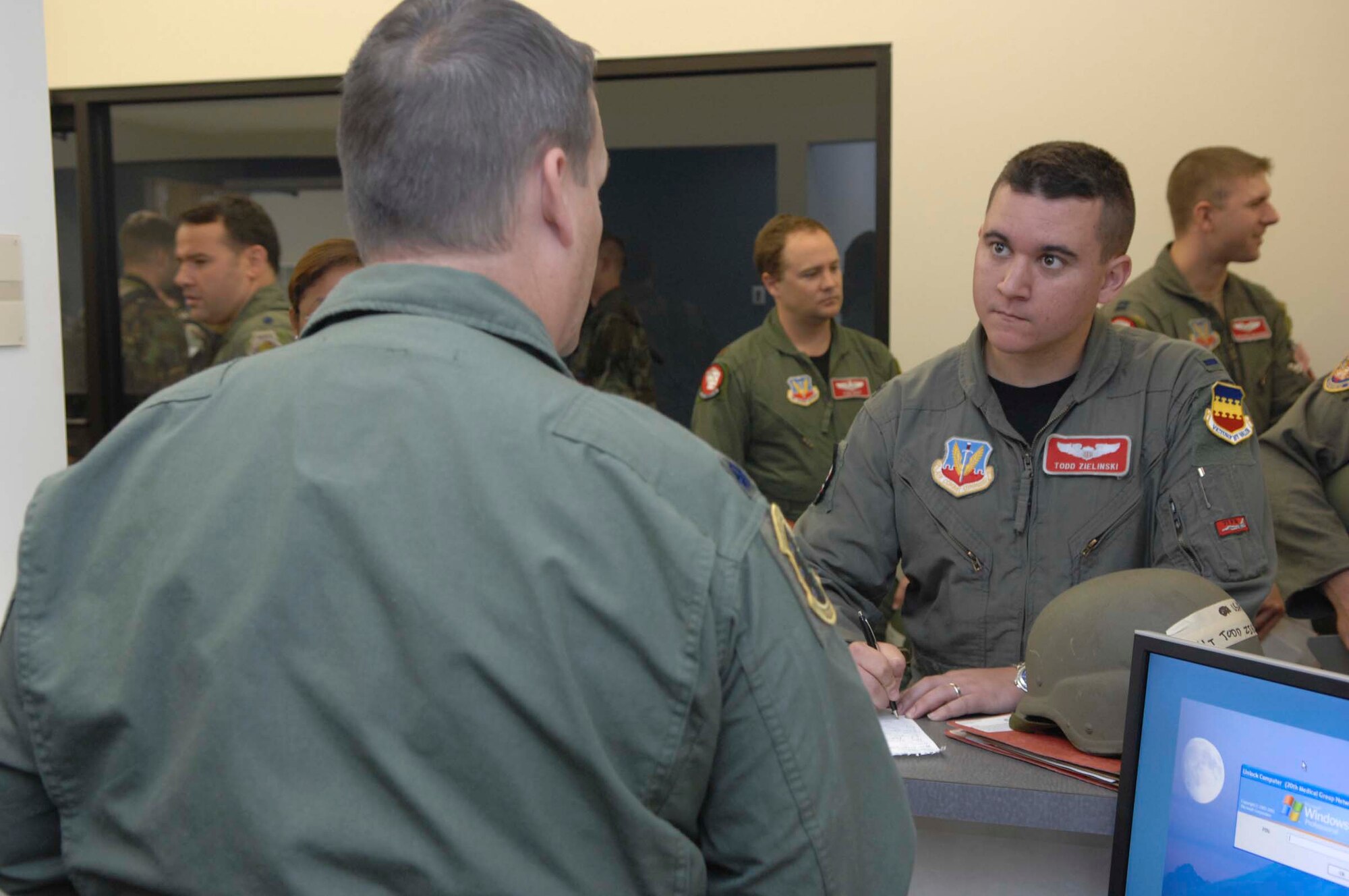 SHAW AIR FORCE BASE, S.C. -- Lt. Col. David Trigg, 20th Aeromedical-Dental Squadron flight surgeon, gives an operational health brief to 1st Lt. Todd Zielinski (right), 77th Fighter Squadron F-16 Fighting Falcon pilot, during a Phase I operational readiness exercise at the Chandler Deployment Processing Center June 18. Phase I exercises are important because they allow the wing to assess a large deployment capability in a controlled environment against a set standard.  (U.S. Air Force Photo/ Airman 1st Class Matthew Davis)